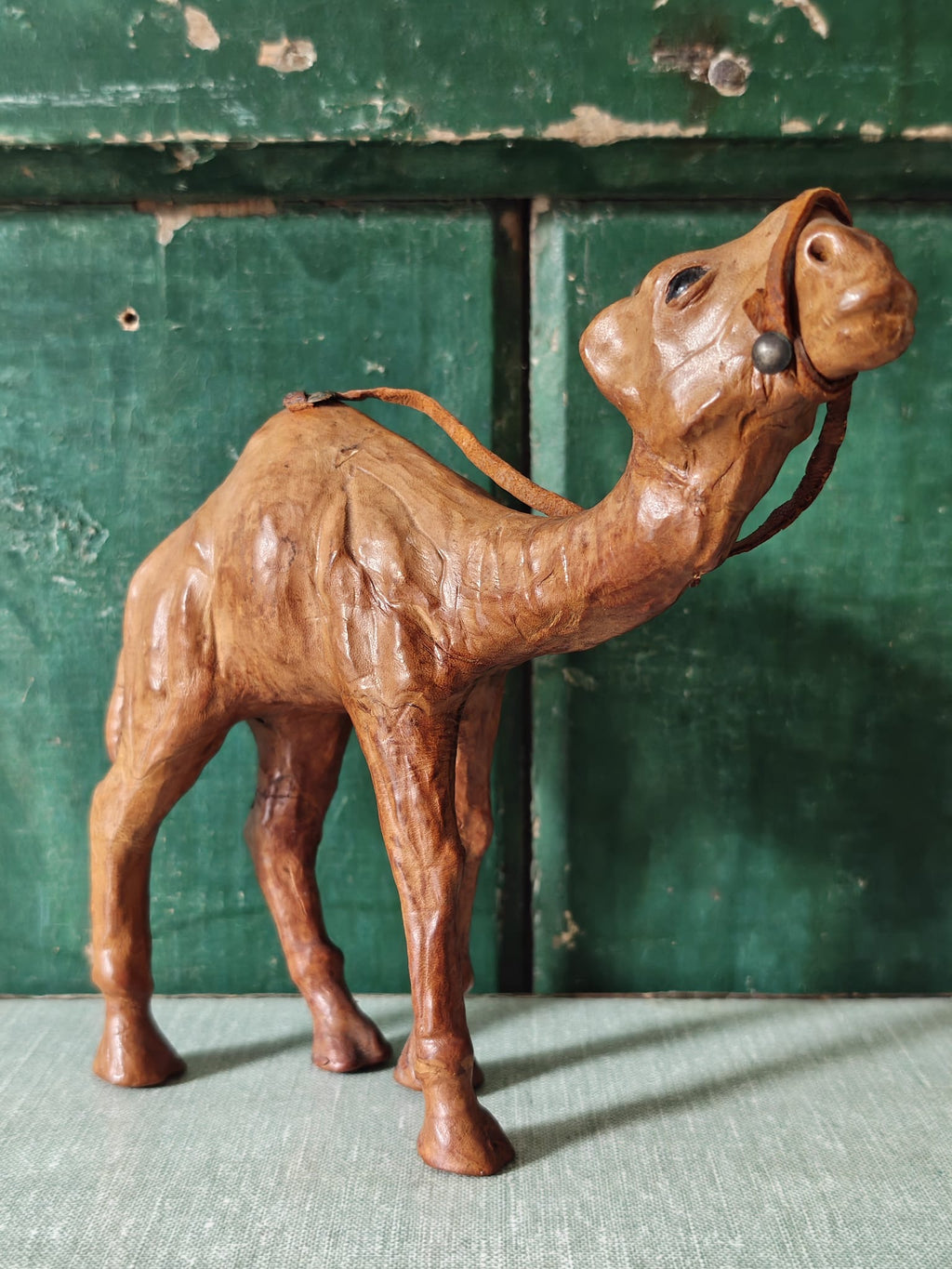 A brown leather covered camel figurine