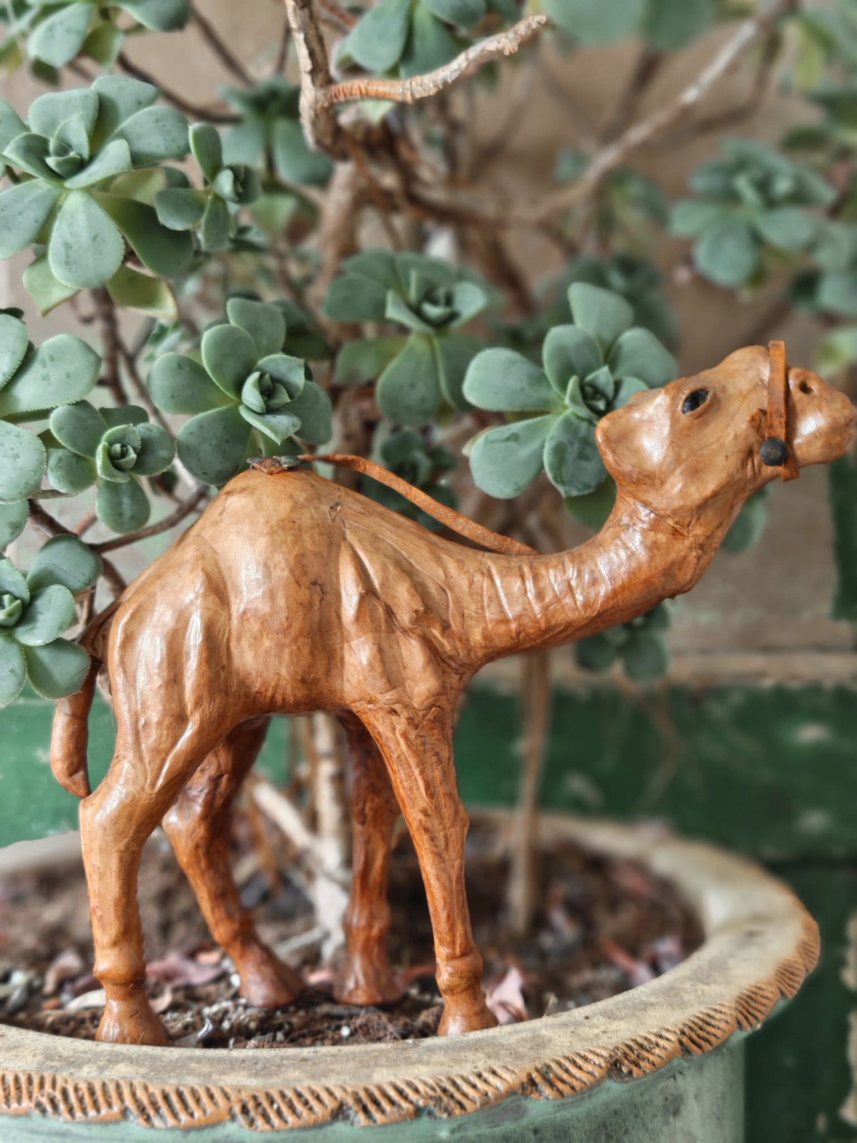 A brown leather covered camel figurine