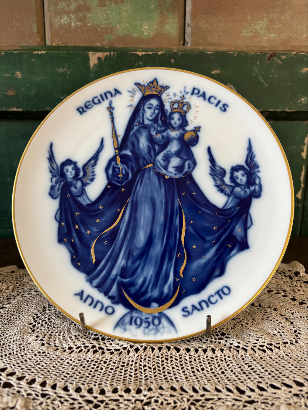 Decorative plate with blue and gold religious design featuring Mary and angels