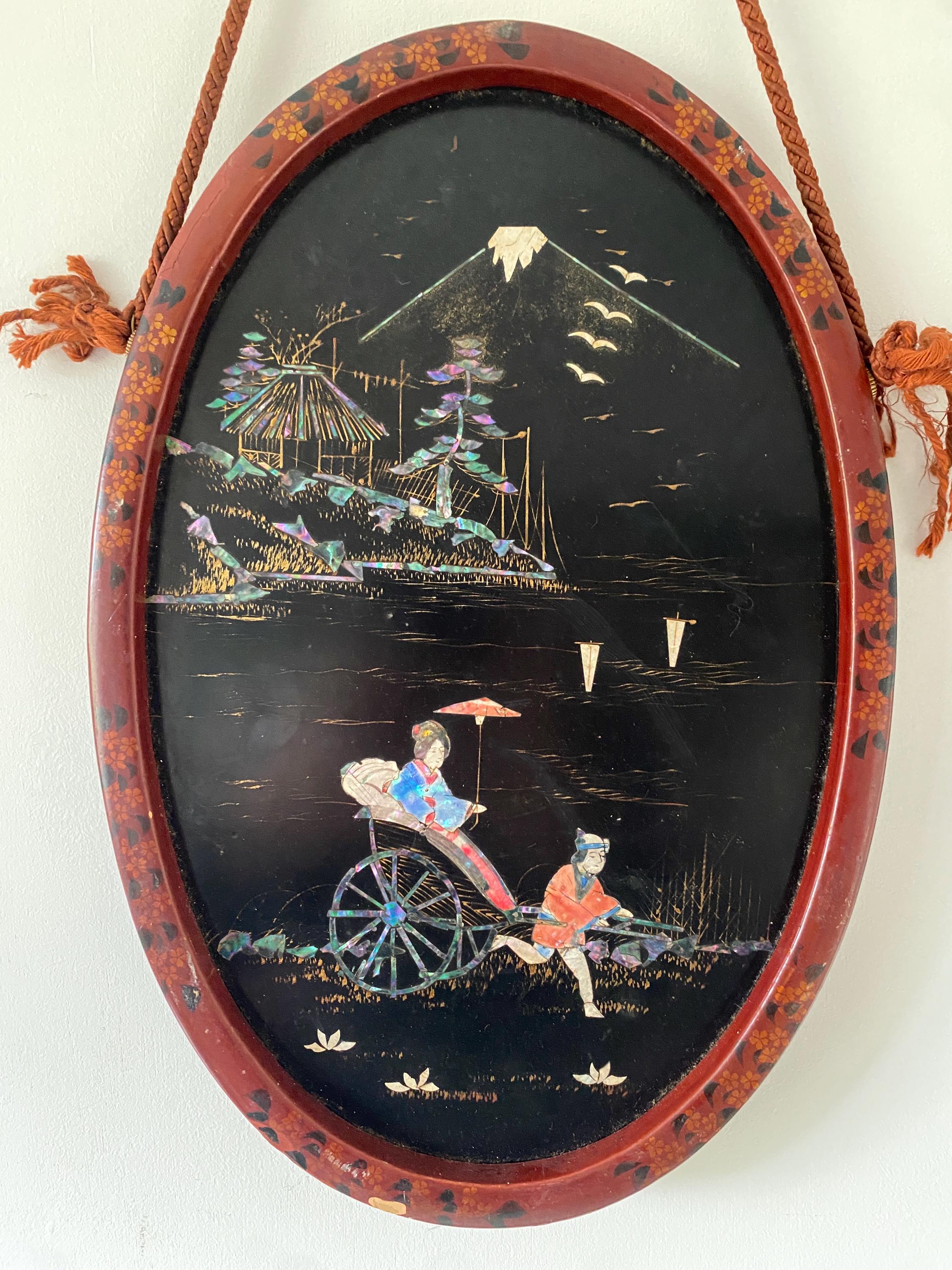 Decorative oval panel with Japanese scene, people, and Mount Fuji.