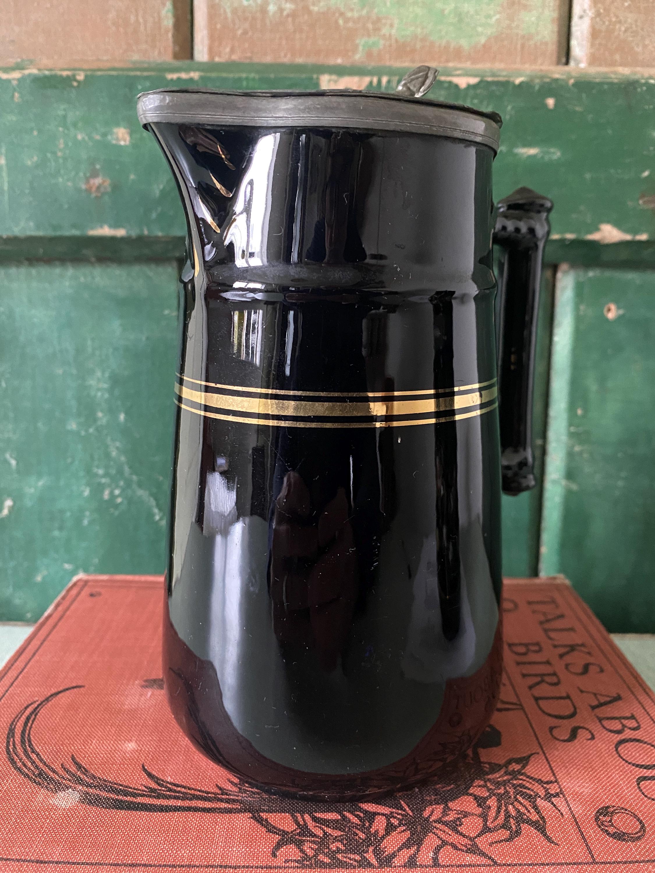 Black glazed pitcher with gold stripe 