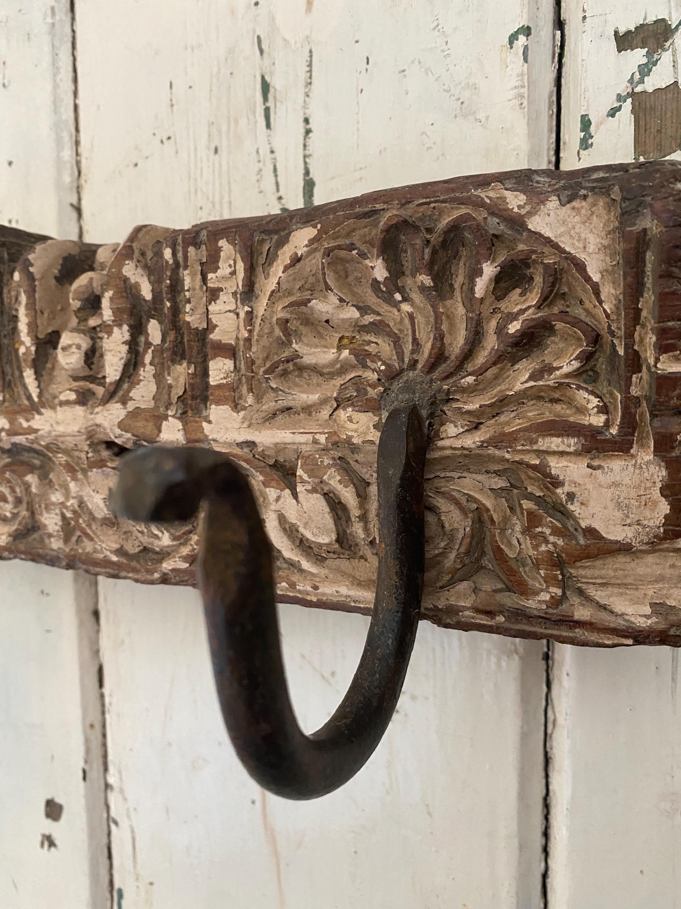 Decorative metal hook with intricate carvings