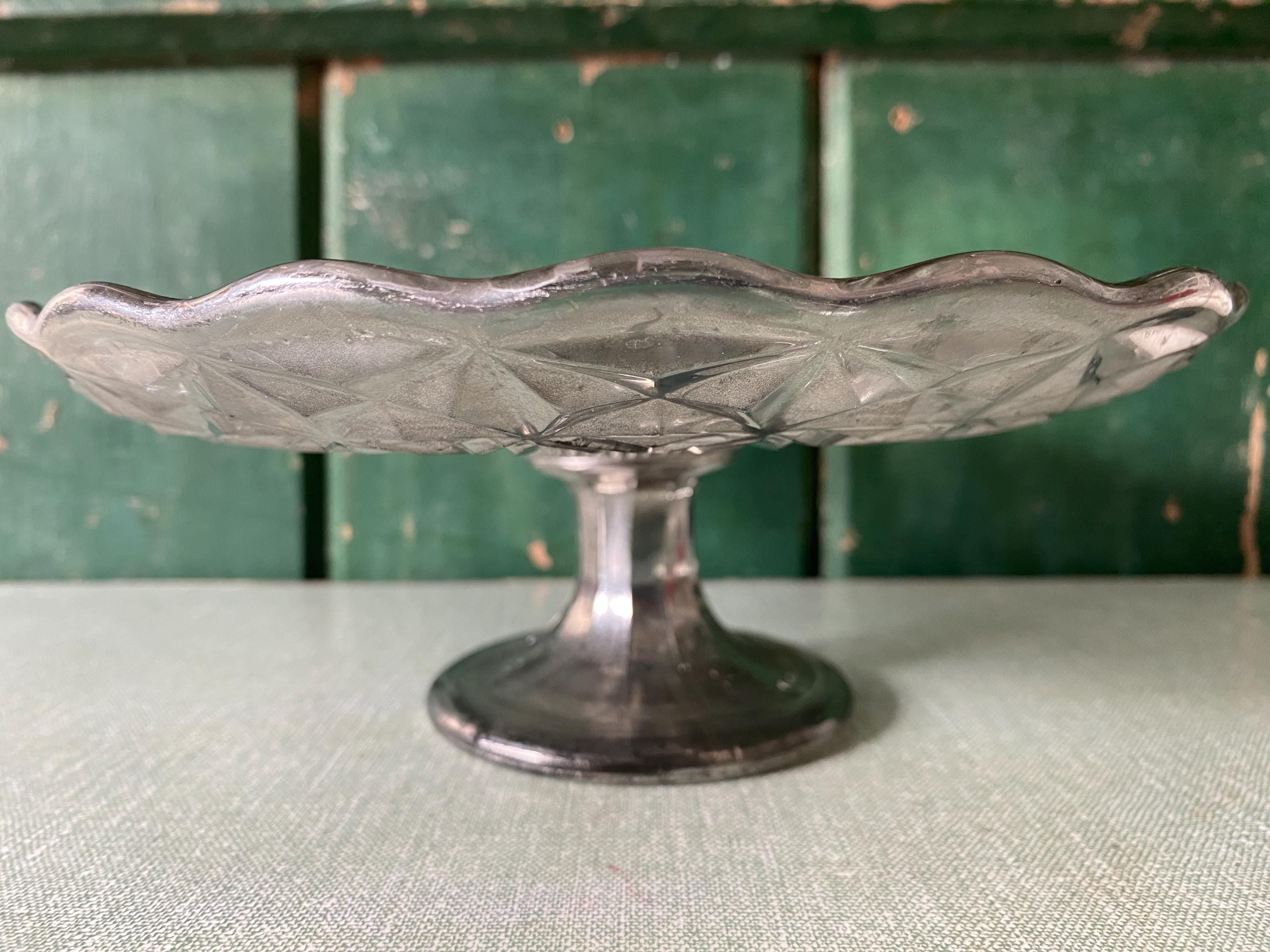 Side view of a decorative mercury glass cake stand 