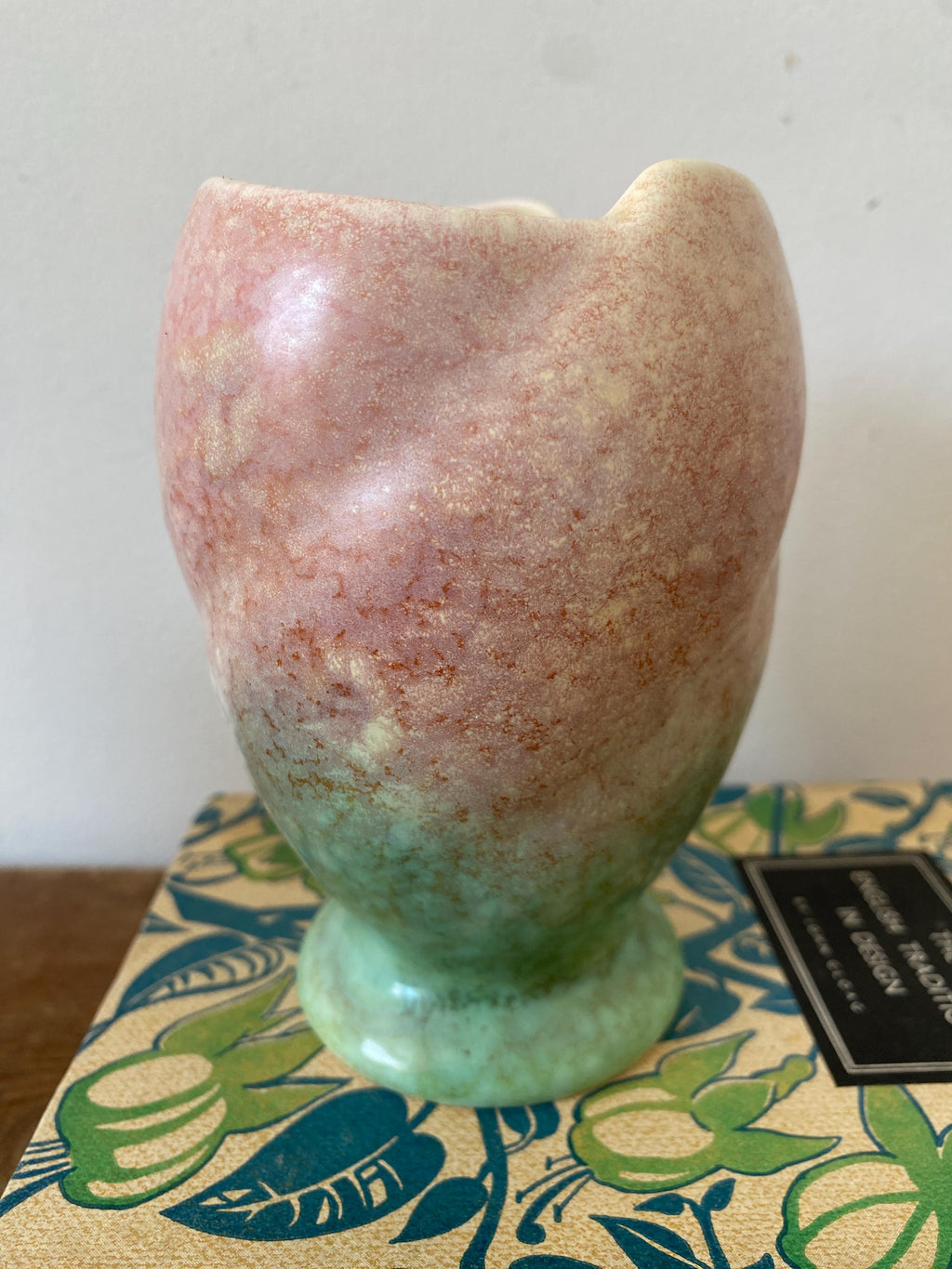 A pink and green ceramic vase