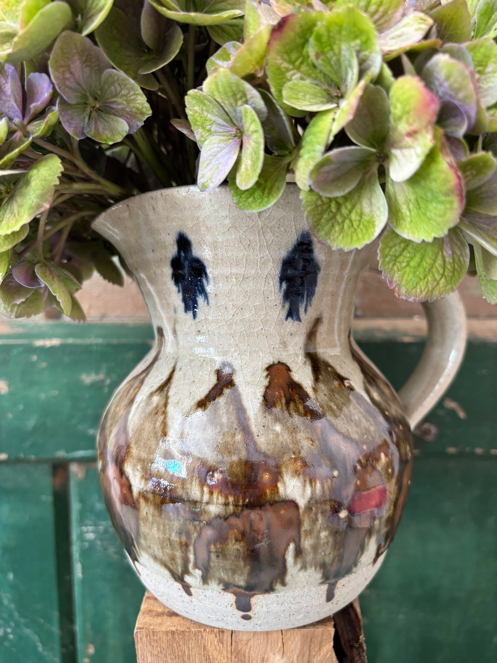 A handmade ceramic pitcher with a rustic glaze.