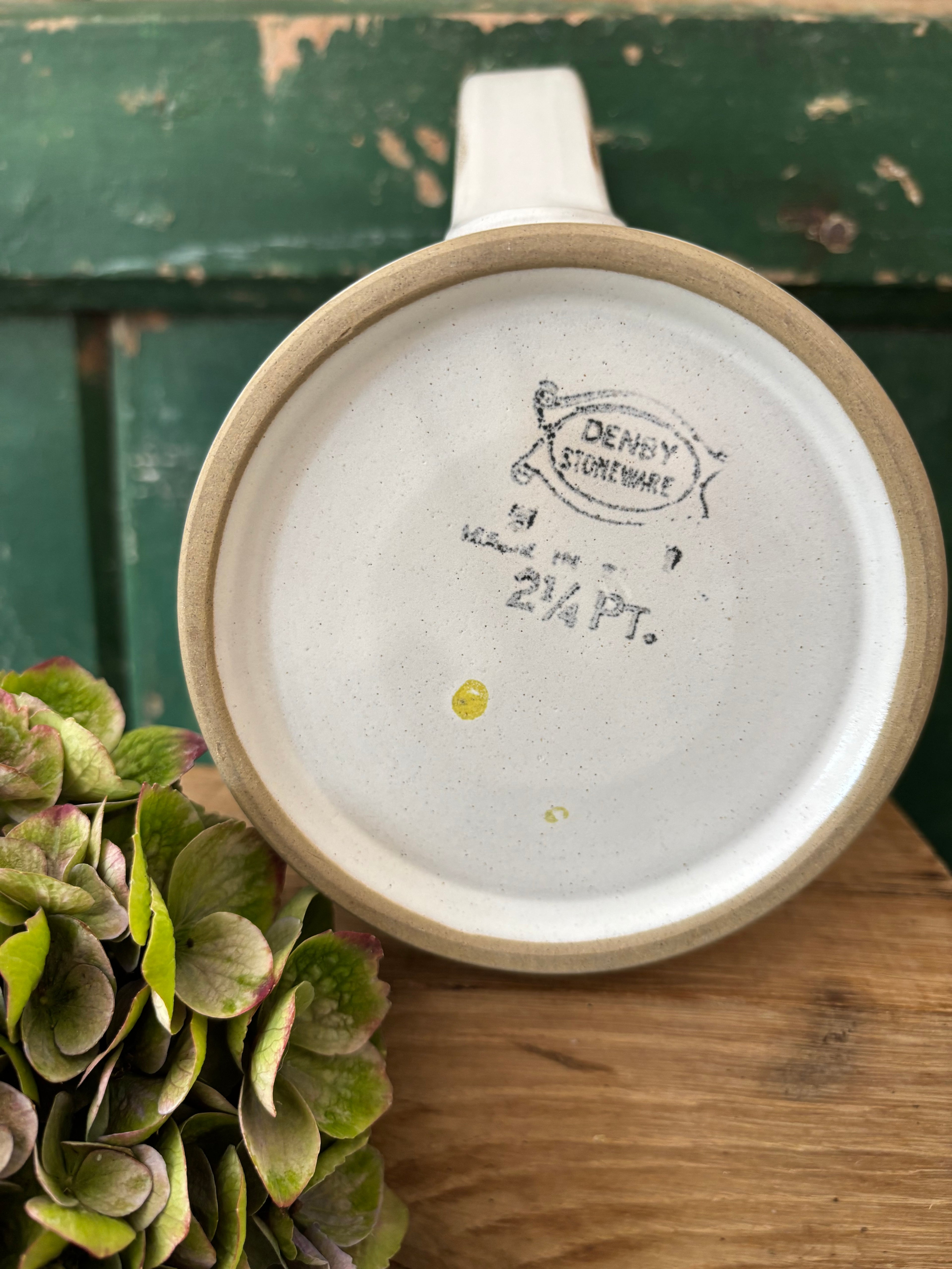 The bottom of a ceramic pitcher showing the brand 'Denby Stoneware'.