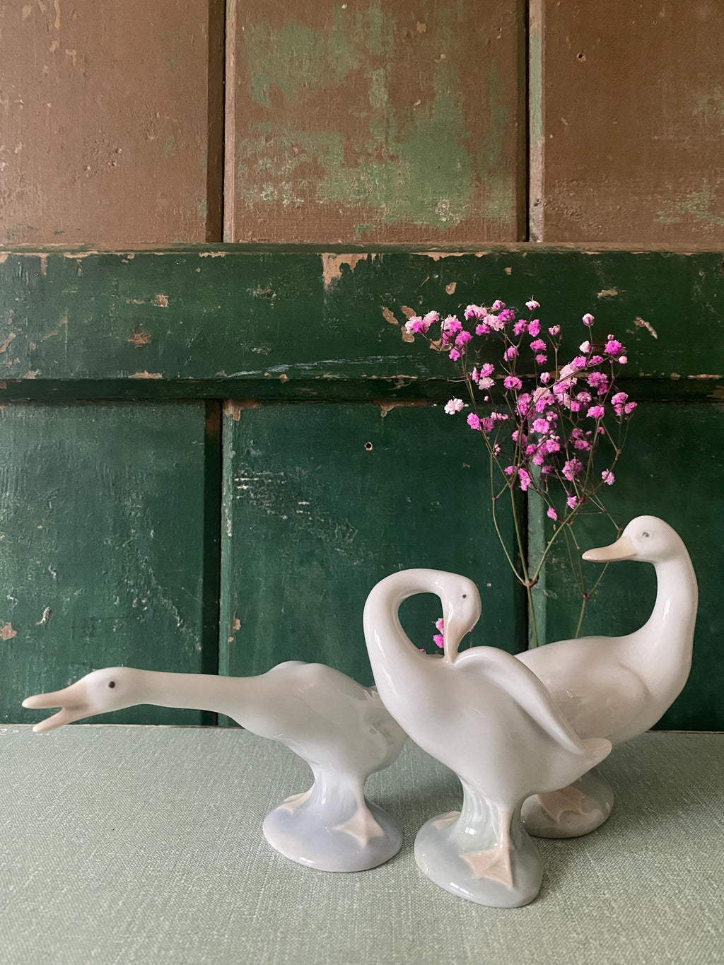 Three white ceramic geese 
