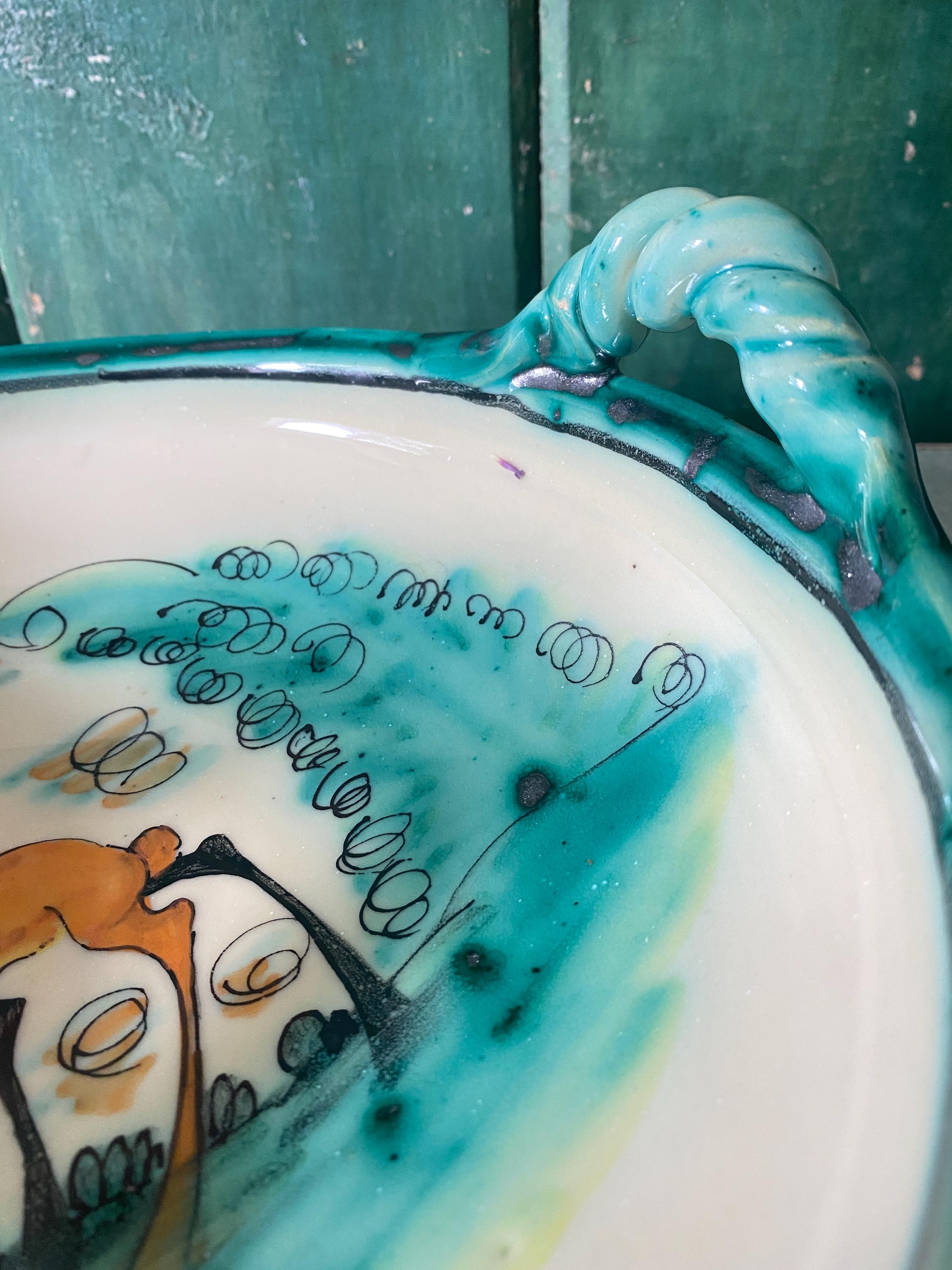 Close up of green ceramic bowl with a handle