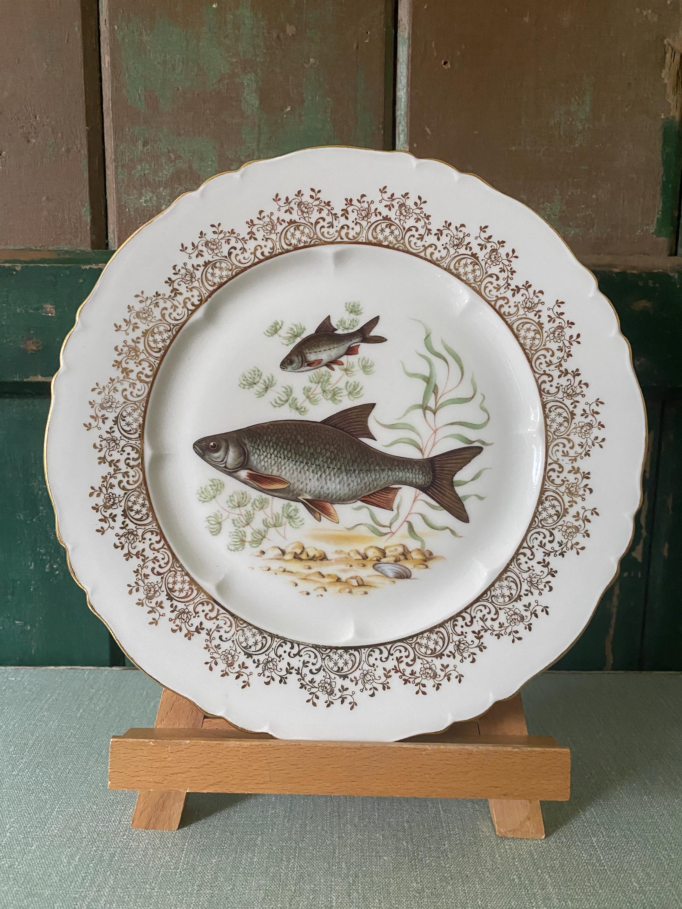 Set of three decorative plates with fish illustrations 