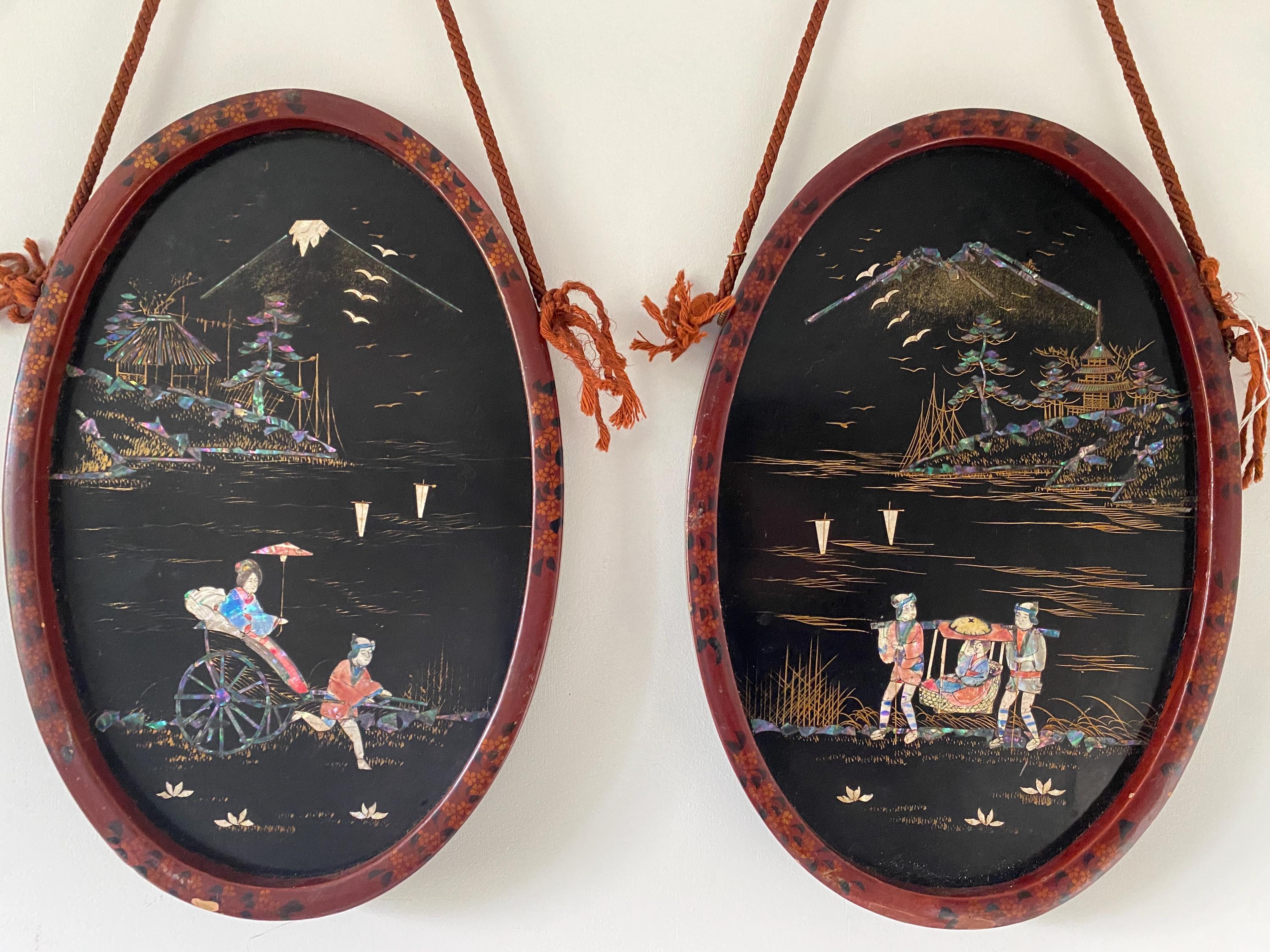 Two oval framed artworks with traditional Japanese scenes