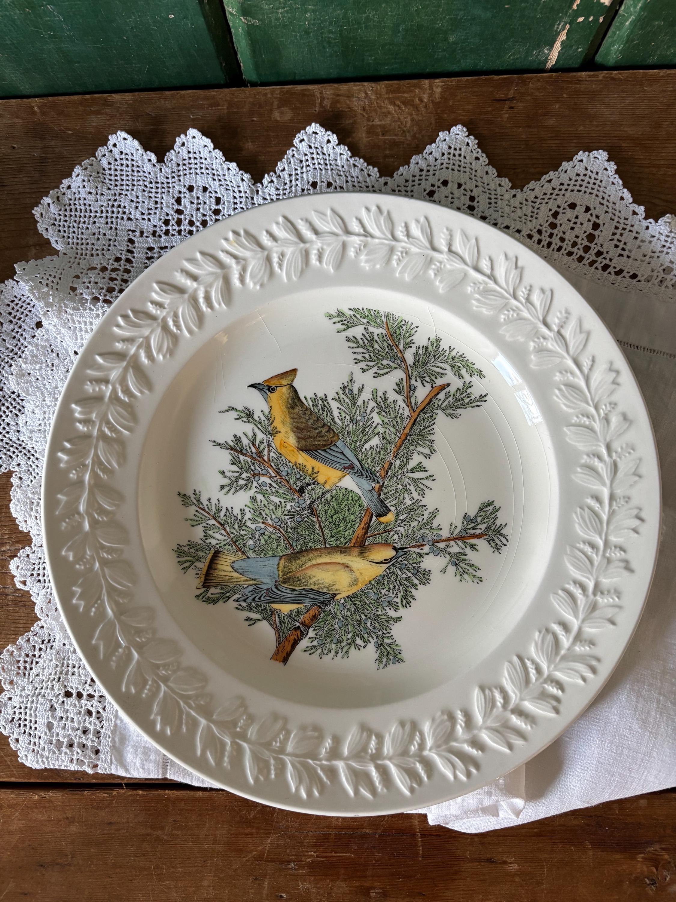Decorative plate with bird and tree design and embossed leaf decoration