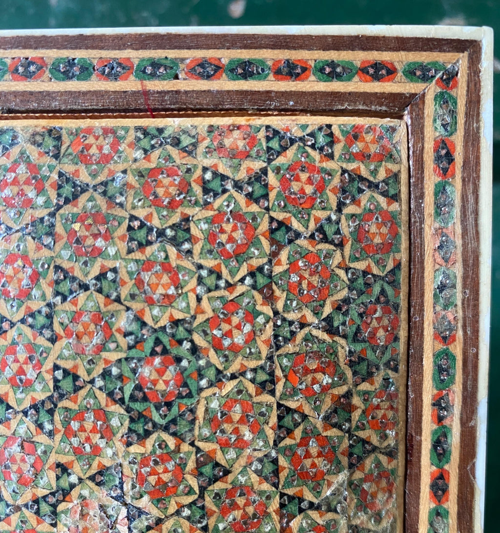Decorative pattern with geometric shapes in red, green, and brown 