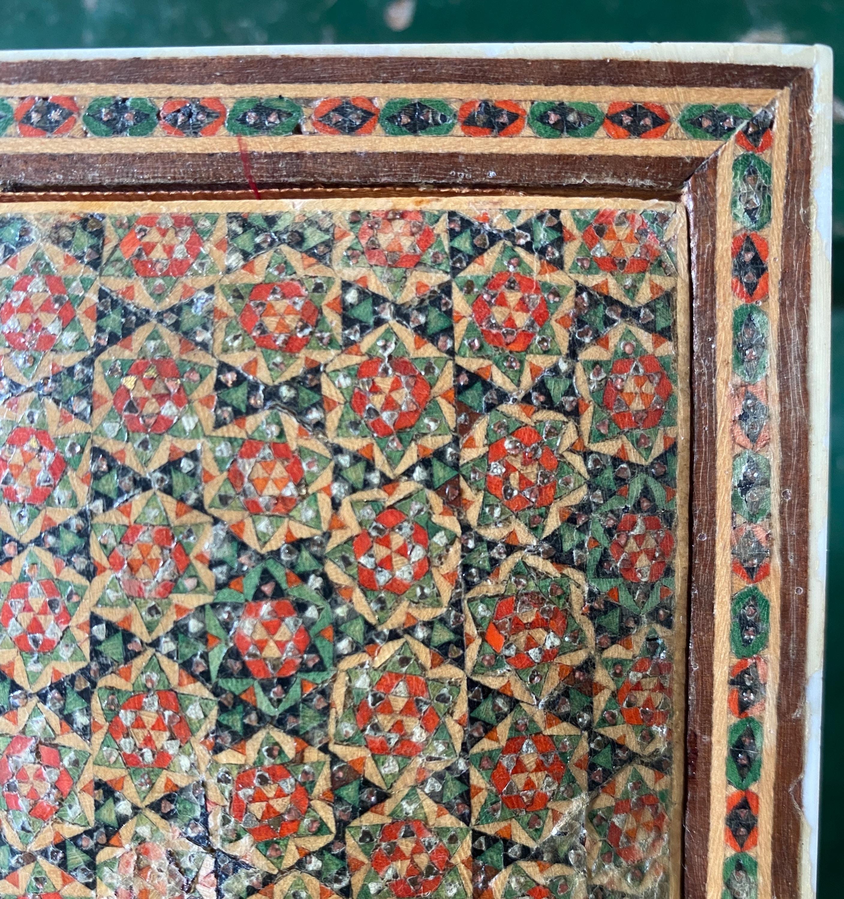 Decorative pattern with geometric shapes in red, green, and brown 