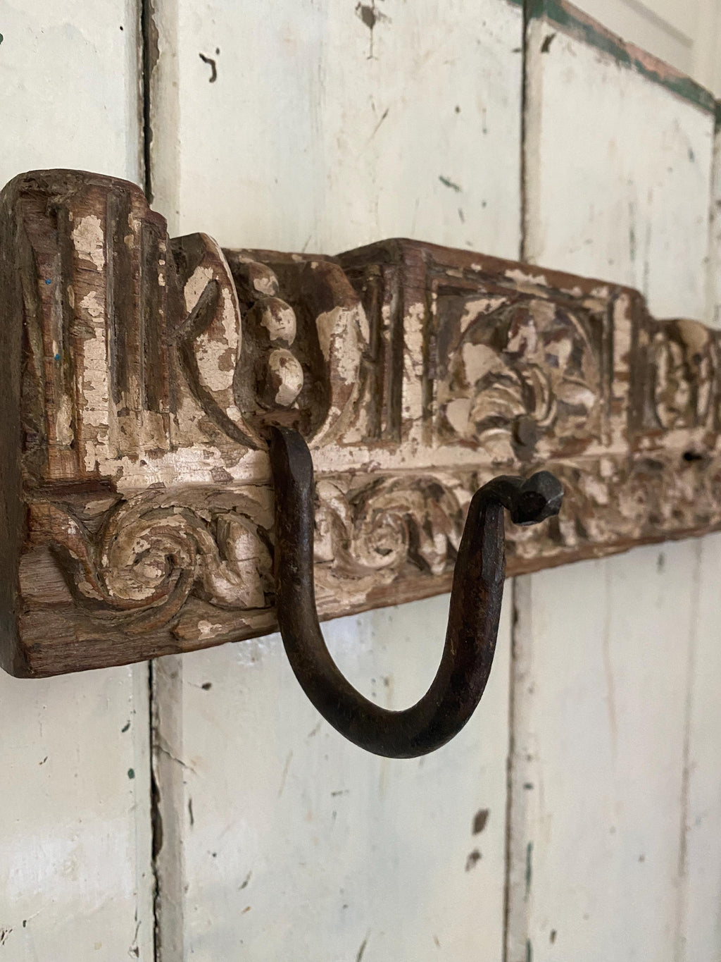 Decorative metal hook on a rustic wooden board 