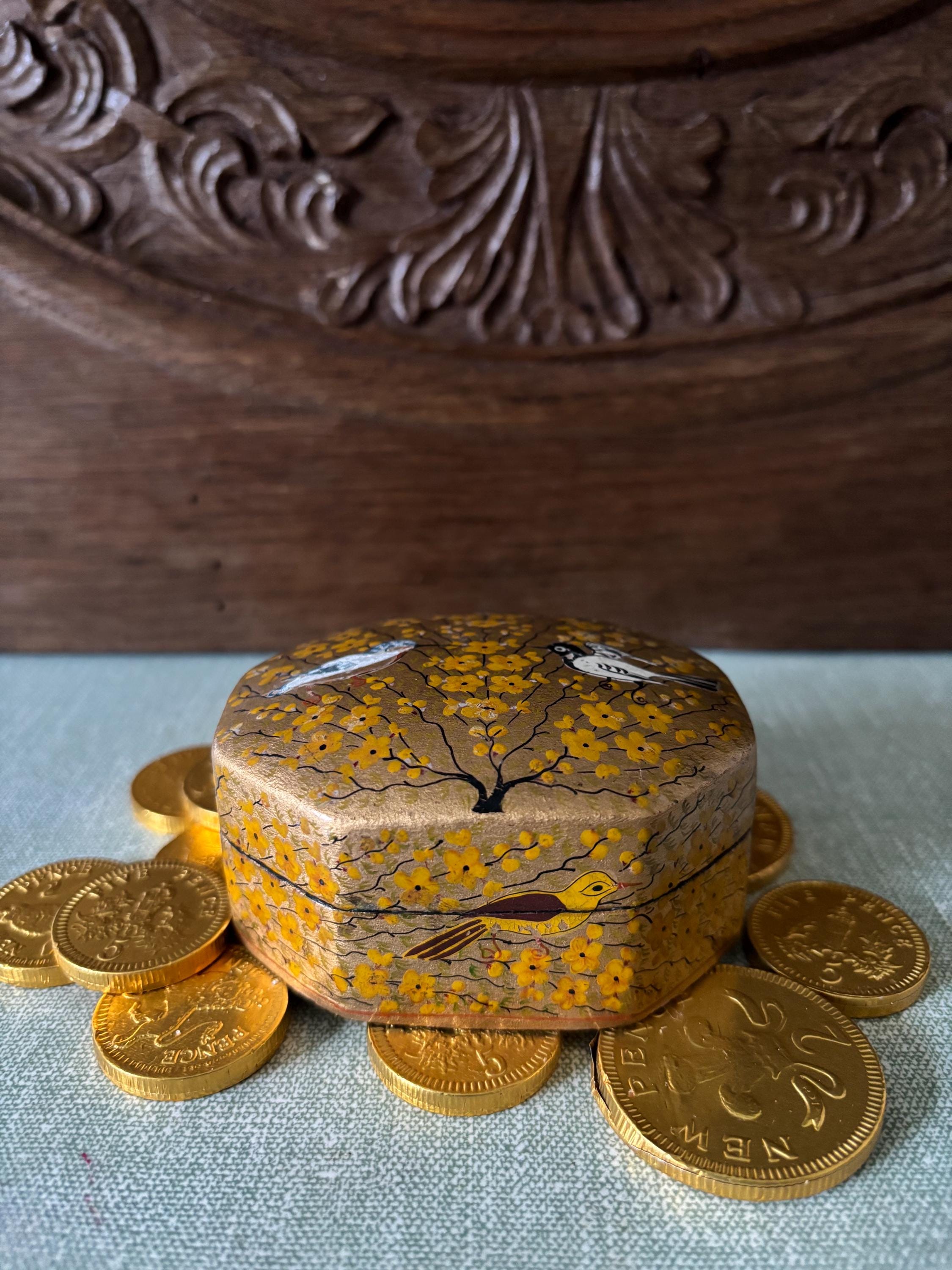 Decorative wooden box with bird pattern.