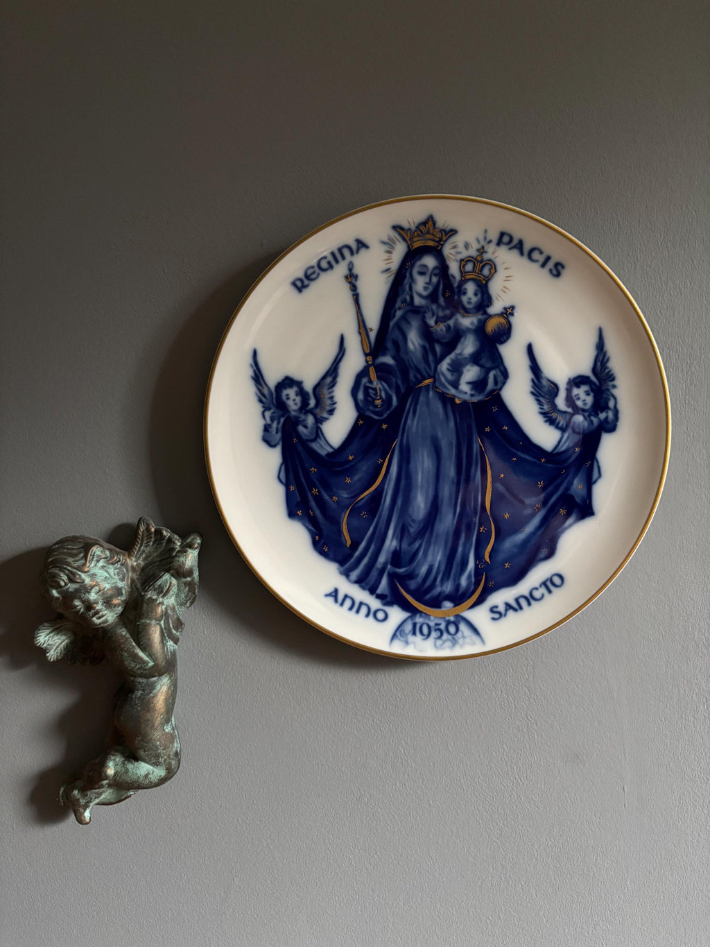 Decorative plate with blue and gold religious design featuring Mary and angels