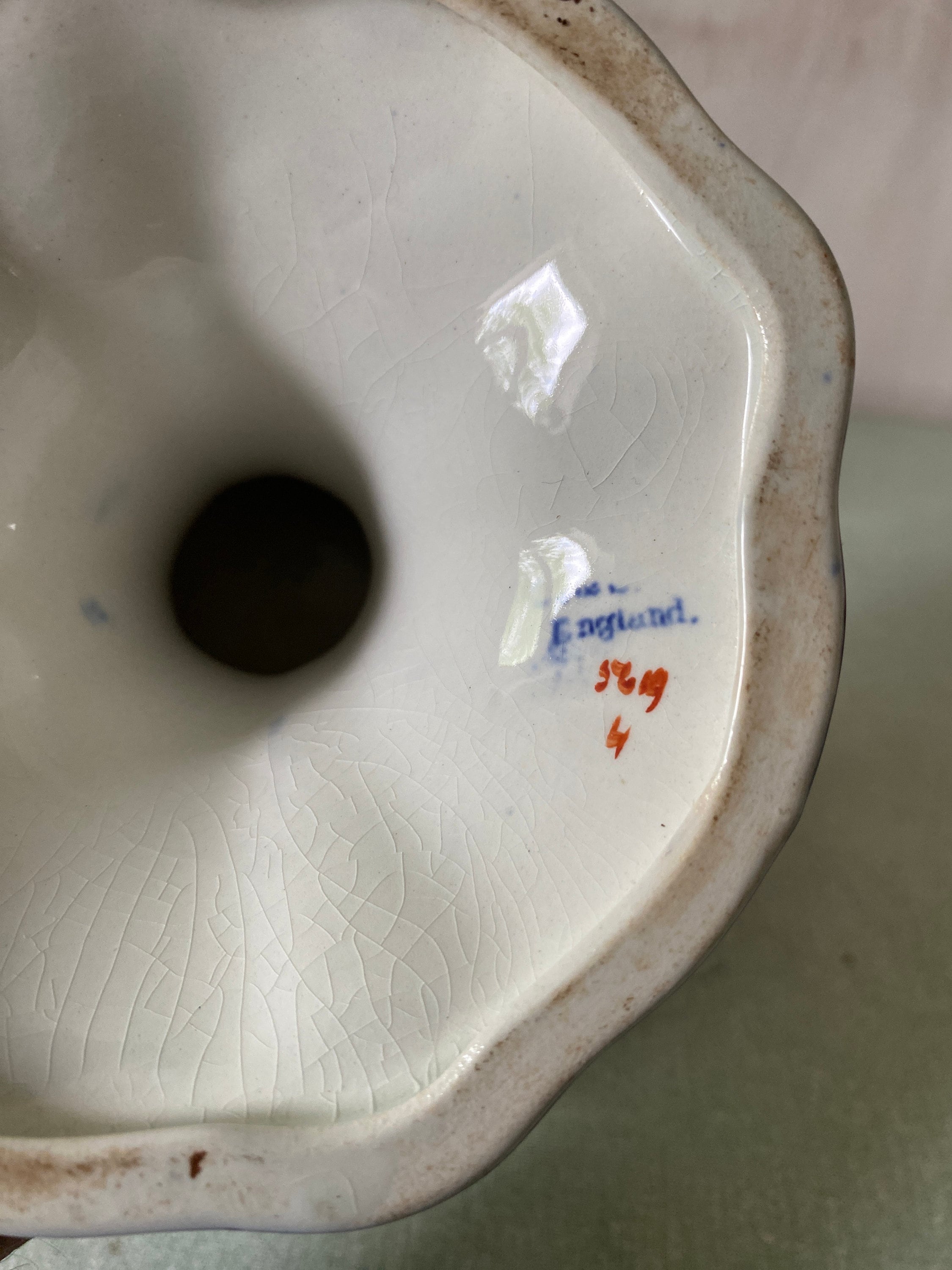 Close-up of a ceramic dish with 'England' and numbers on the base.