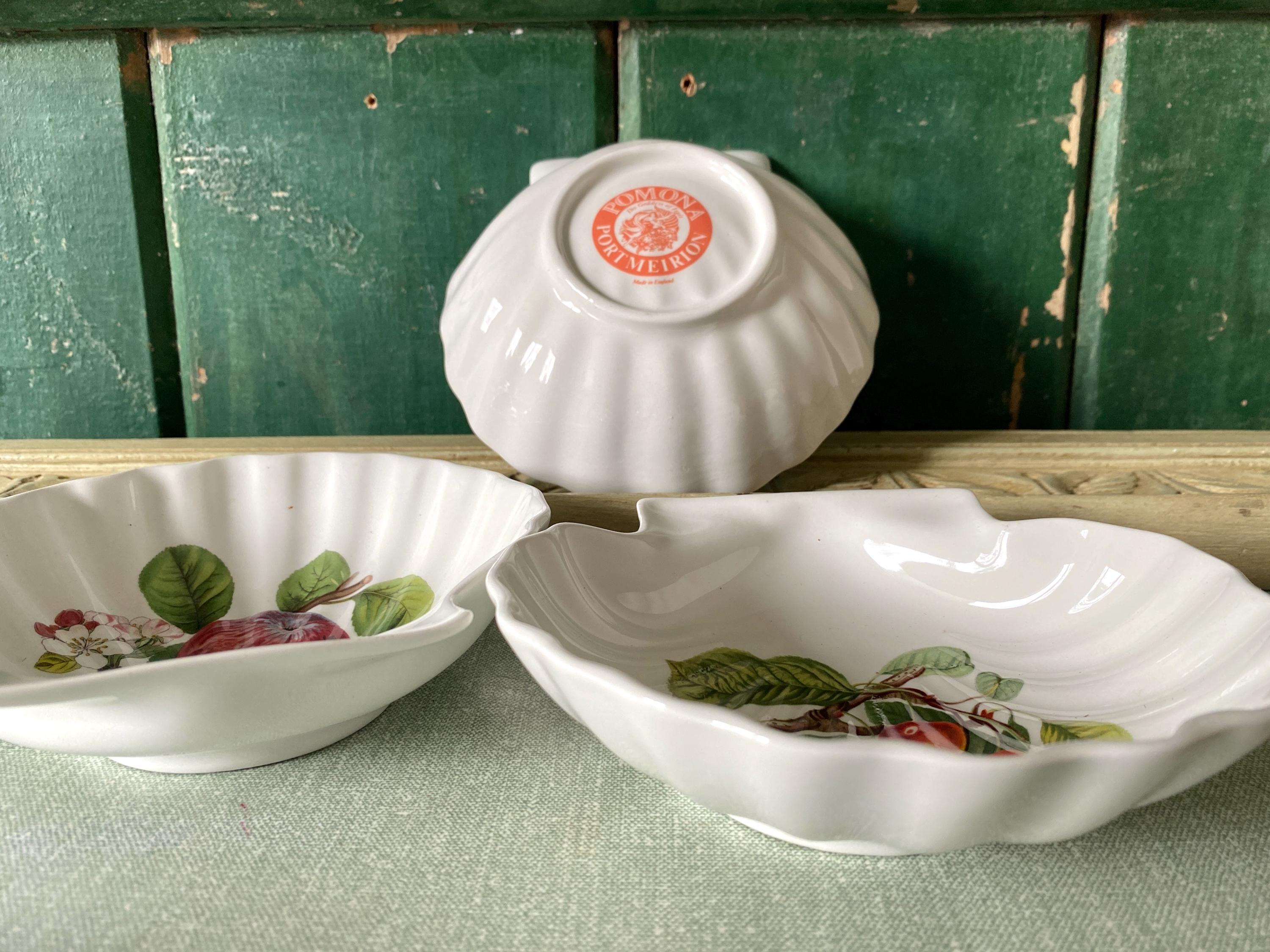 Three white ceramic bowls with floral patterns