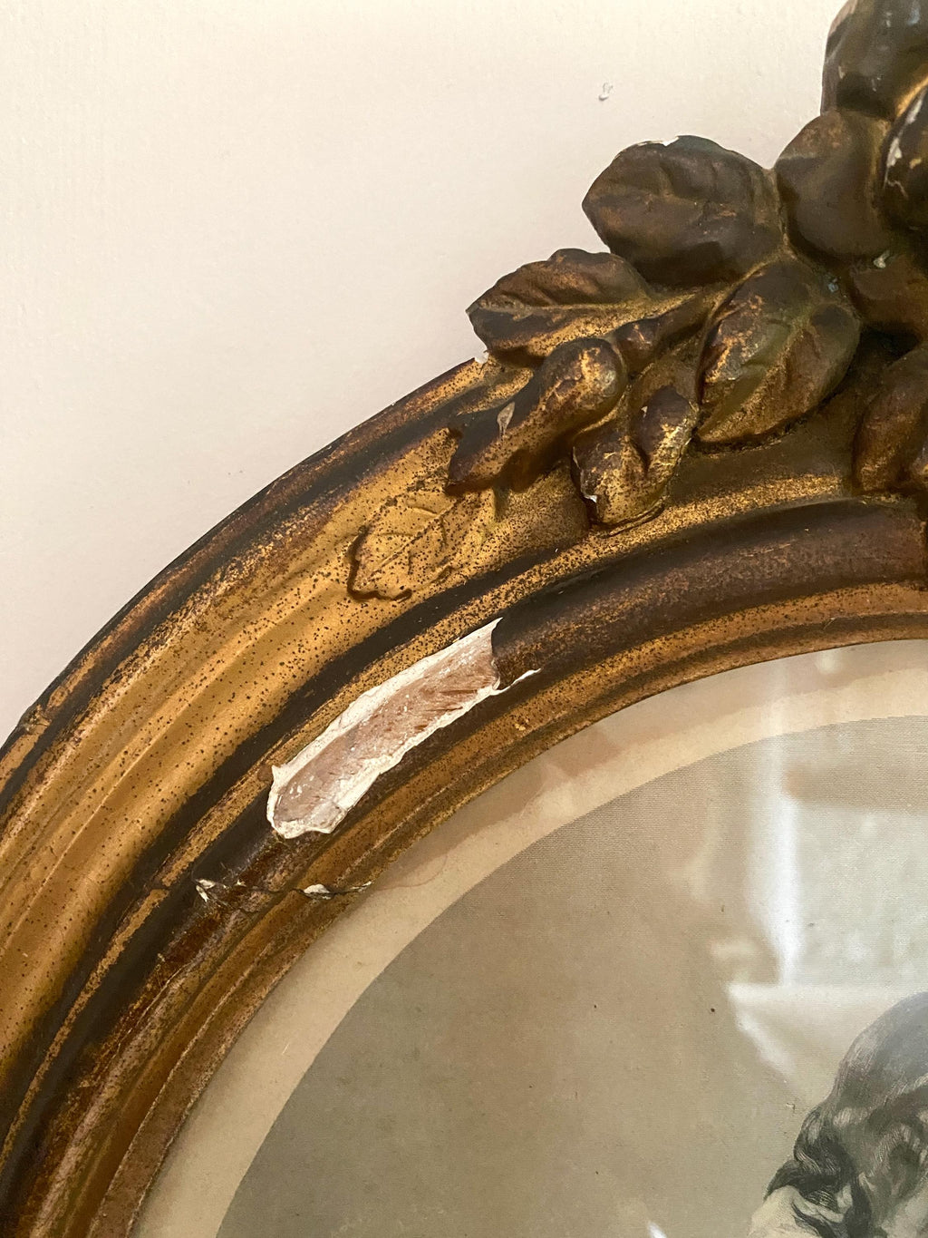 Detail of decorative gold frame with leaf moulding