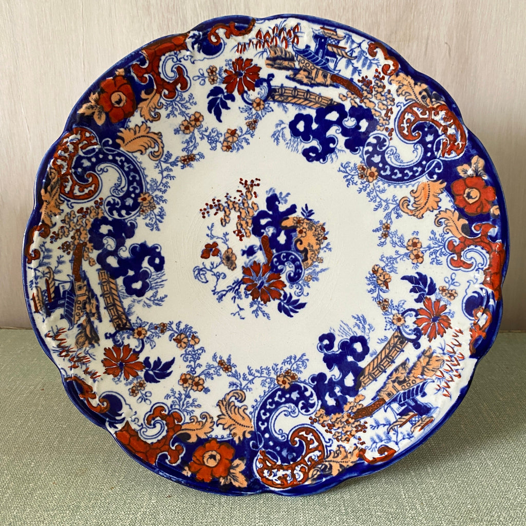 Decorative plate with blue and orange floral pattern