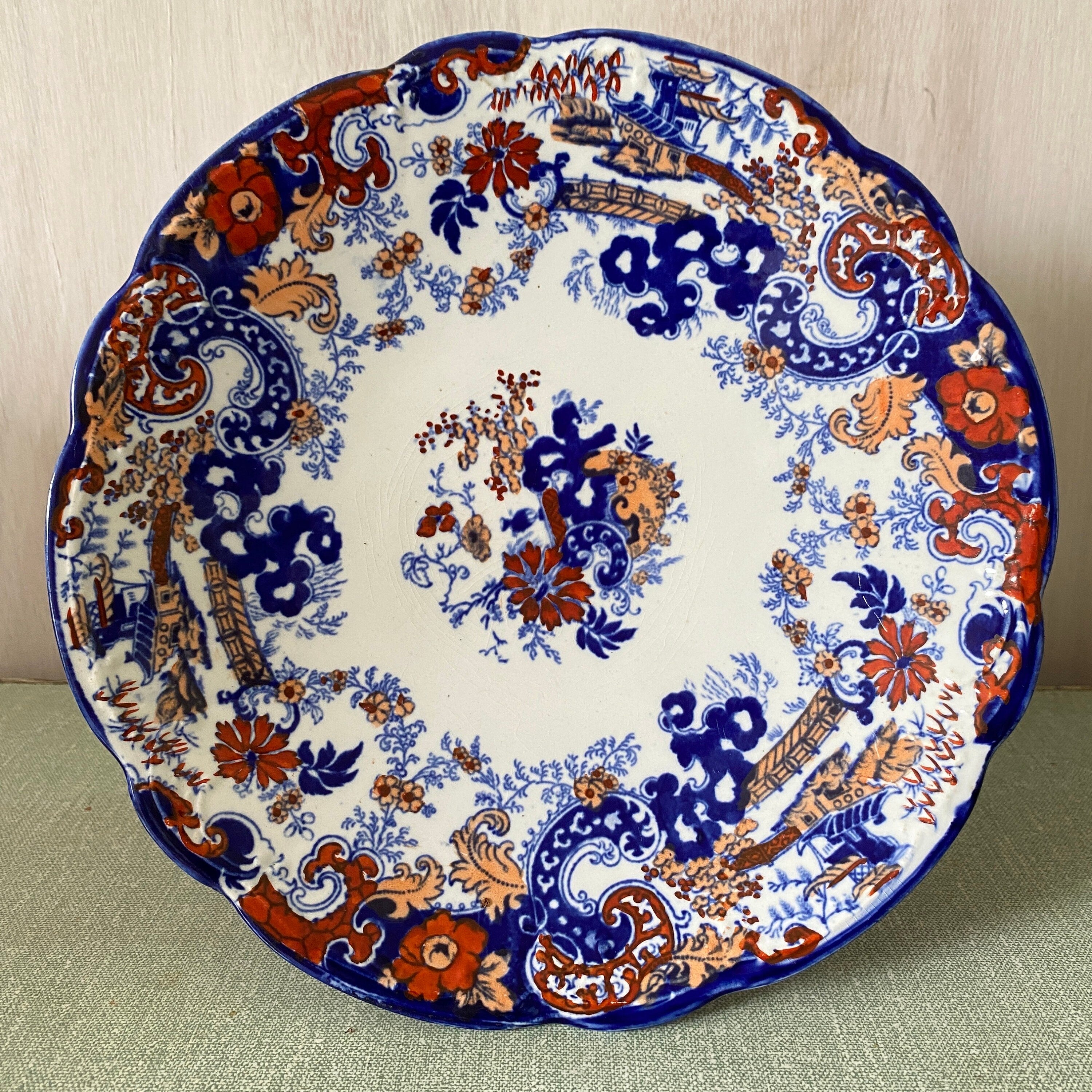 Decorative plate with blue and orange floral pattern