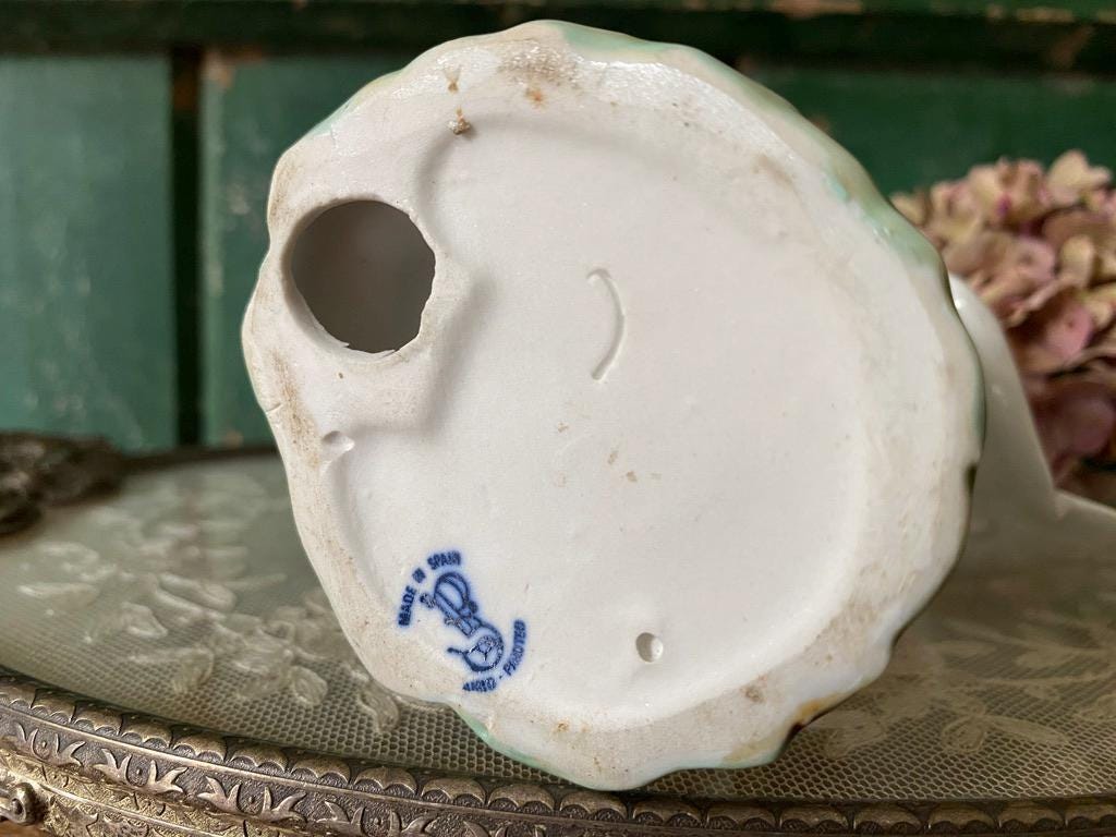 Base of a ceramic figurine showing maker's mark