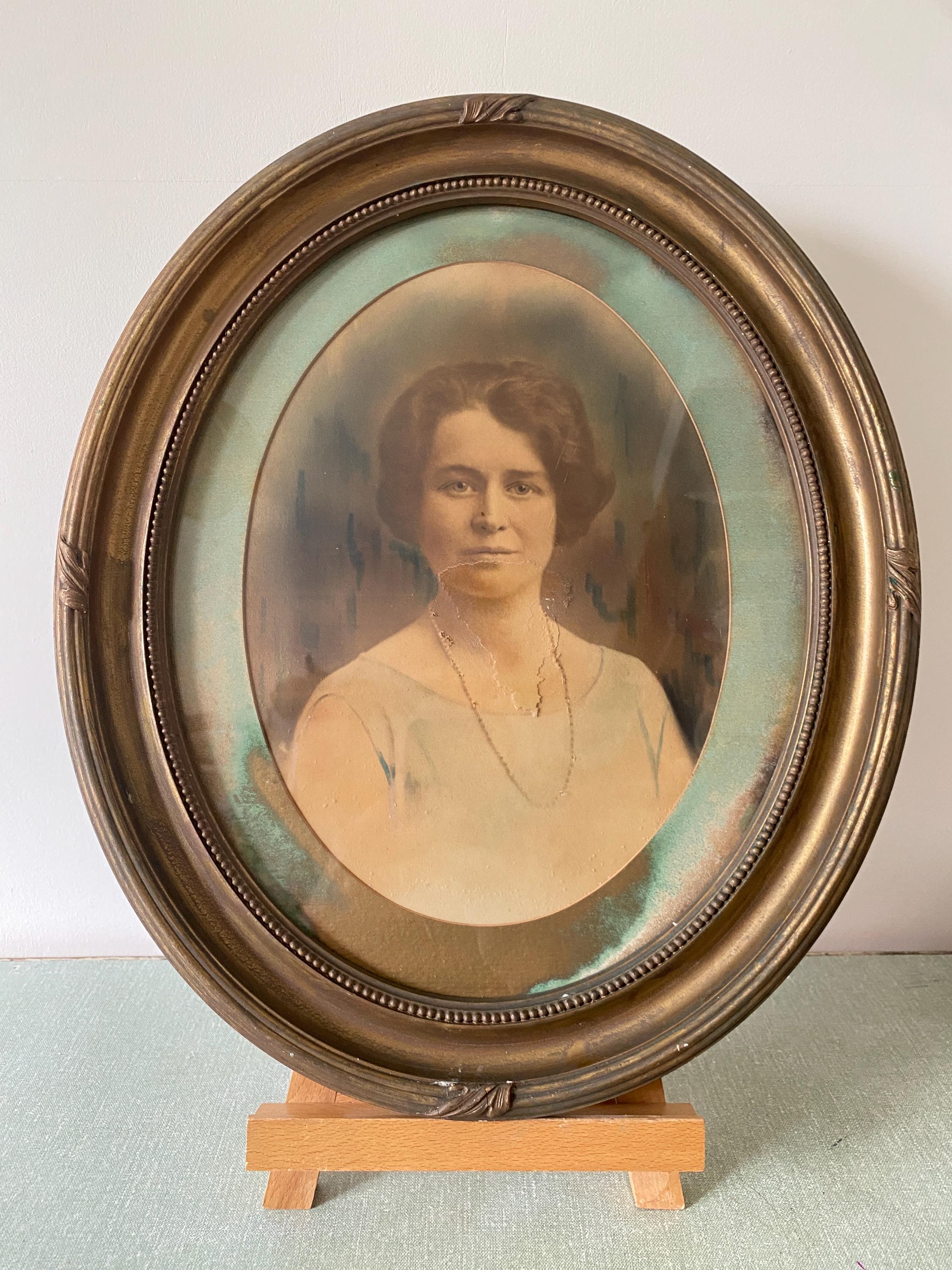 Vintage portrait of a woman in an oval gold frame