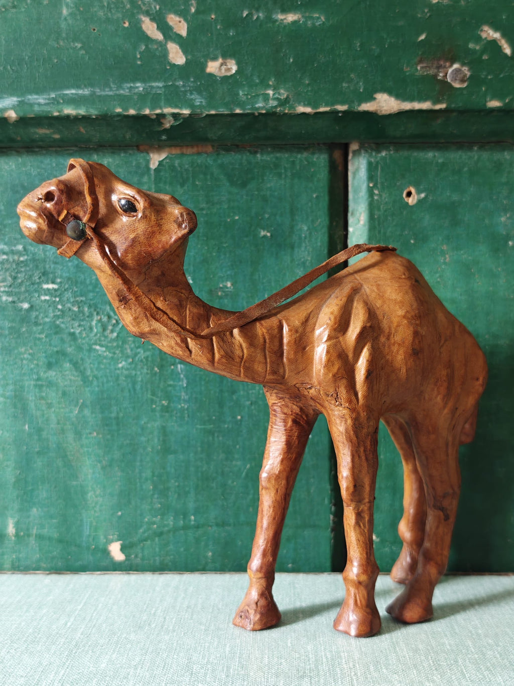 A brown leather covered camel figurine