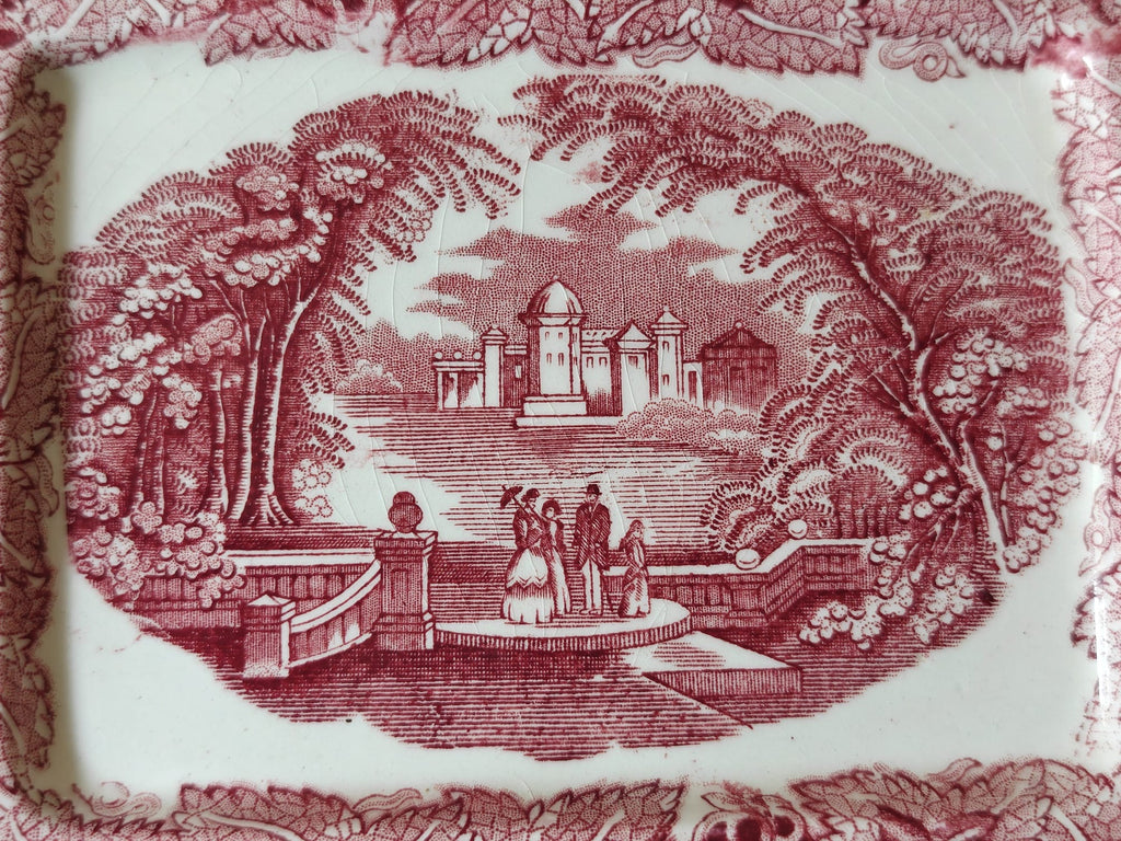 The base of a Masons Vista butter dish showing the traditional landscape transfer print.