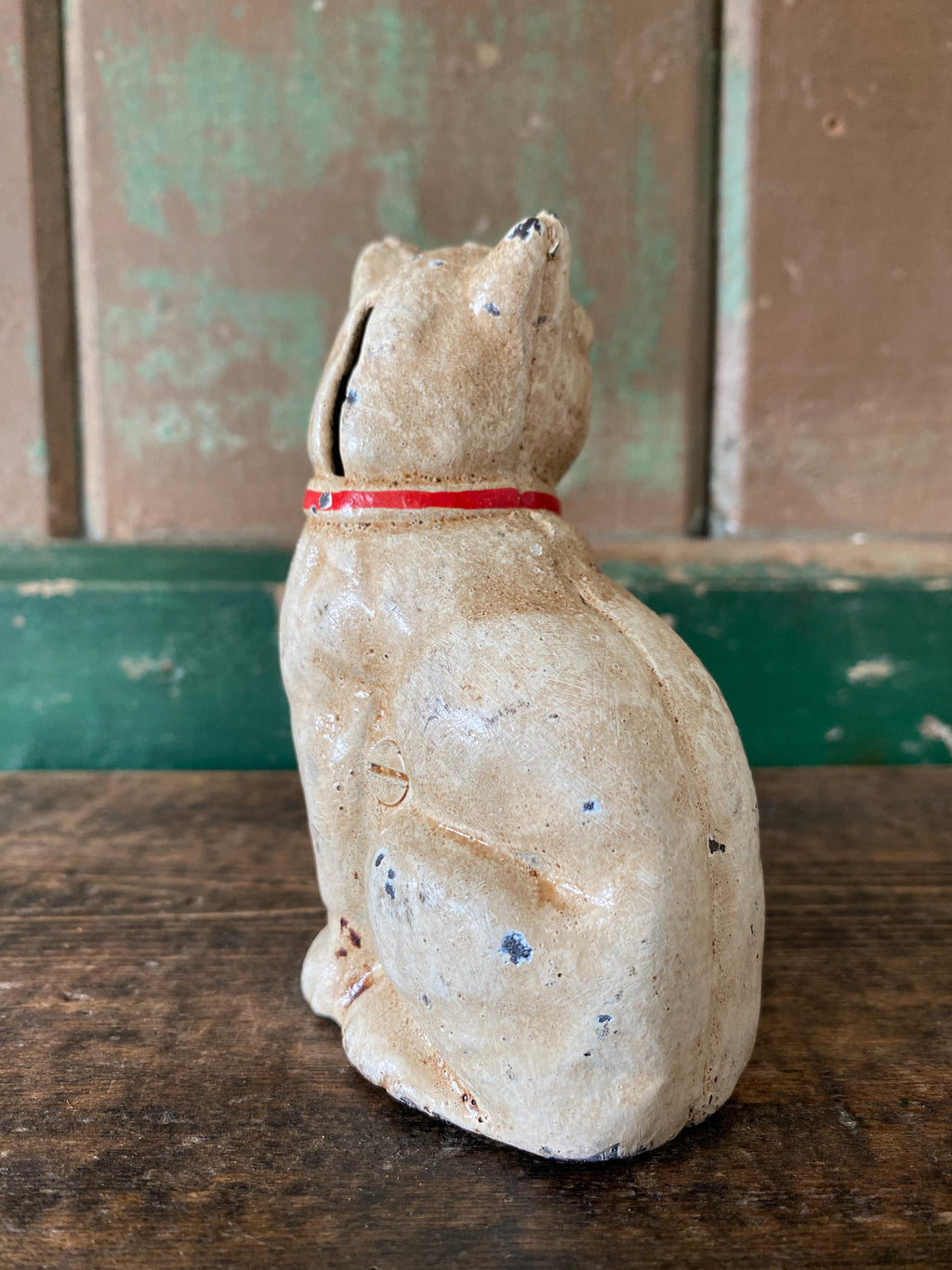 Vintage metal cat shaped money box with red ribbon
