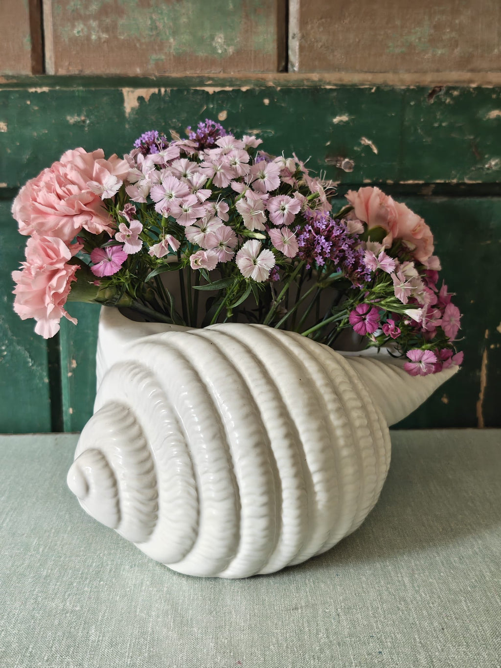 A white ceramic seashell-shaped vase from Shorter and Son.