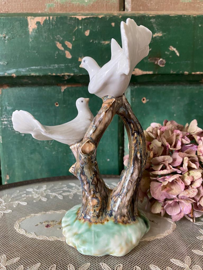 Ceramic dove figurine on a branch 