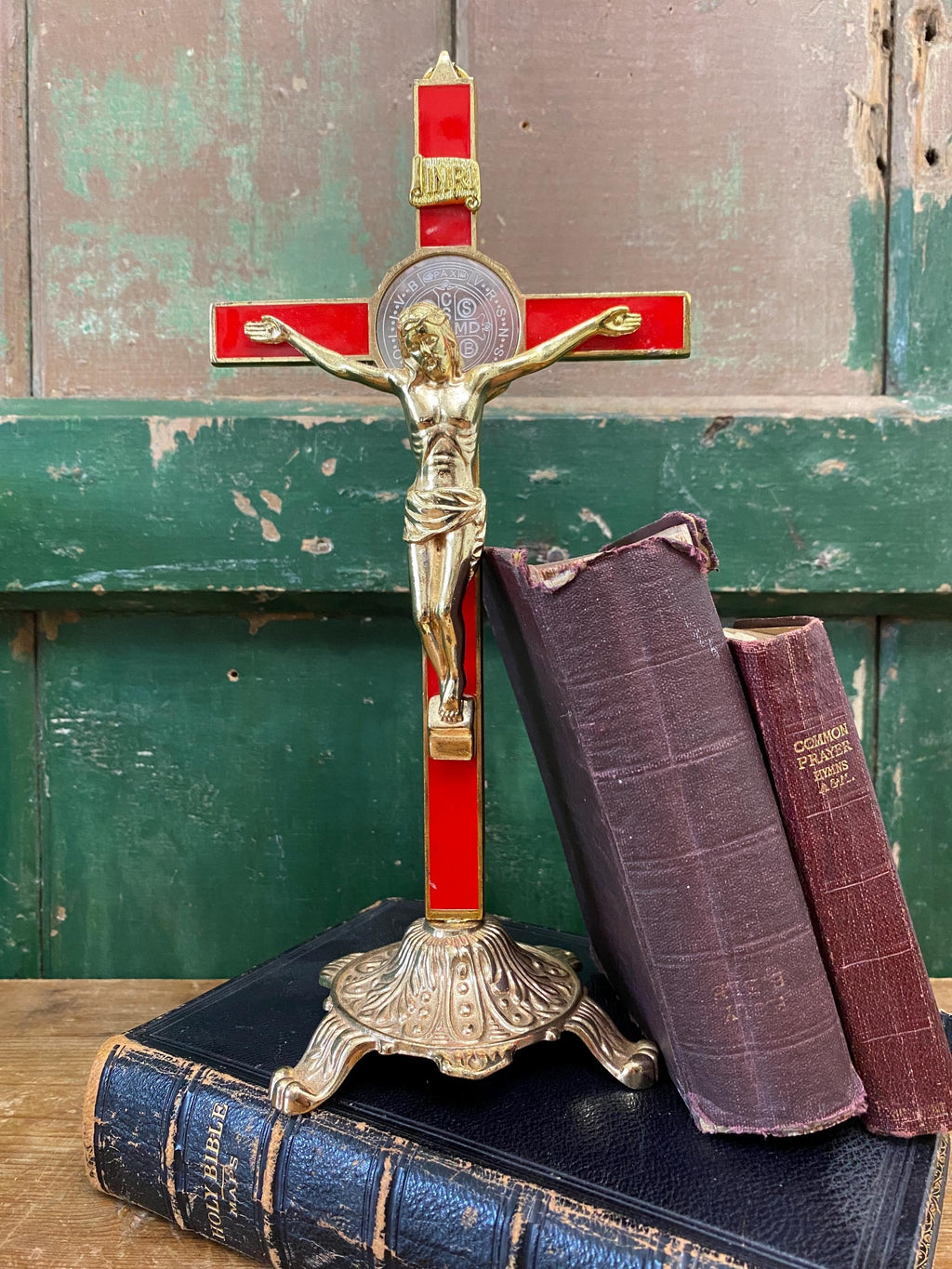 Gold and red decorative crucifix on a stand