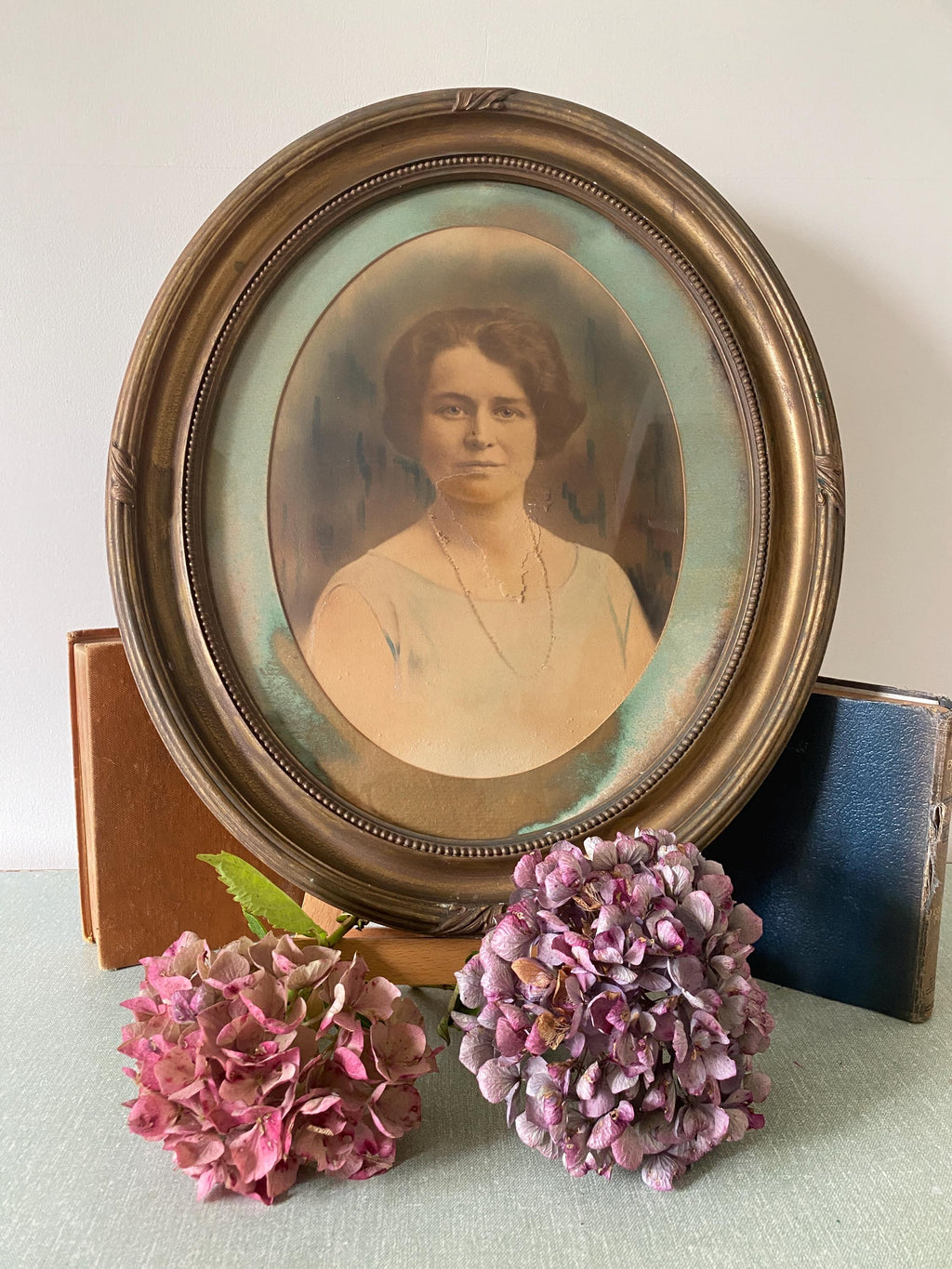 Vintage portrait of a woman in an oval gold frame