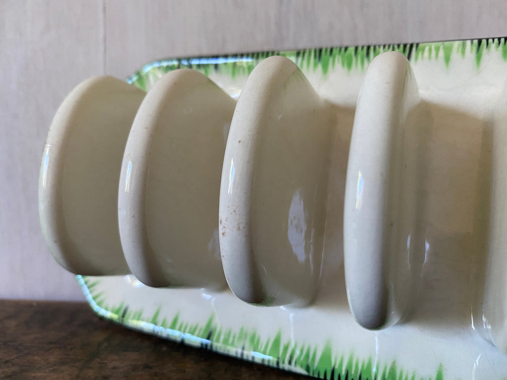 side vew of a green and white ceramic toast rack