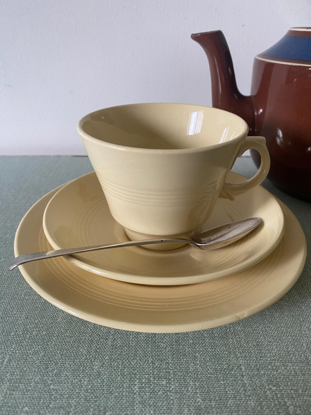 Yellow ceramic cup, saucer, and plate