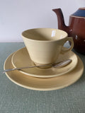 Yellow ceramic cup, saucer, and plate