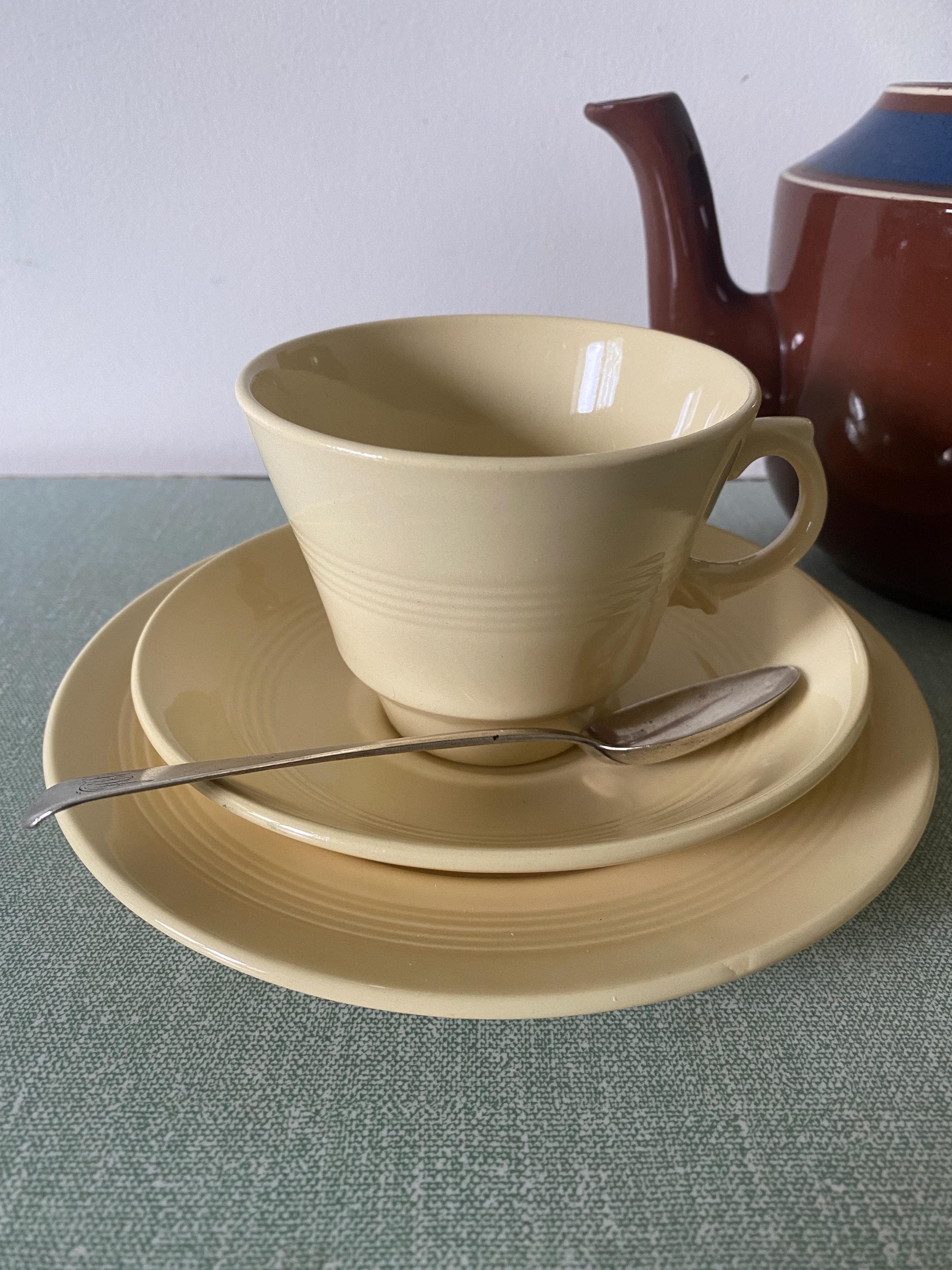 Yellow ceramic cup, saucer, and plate