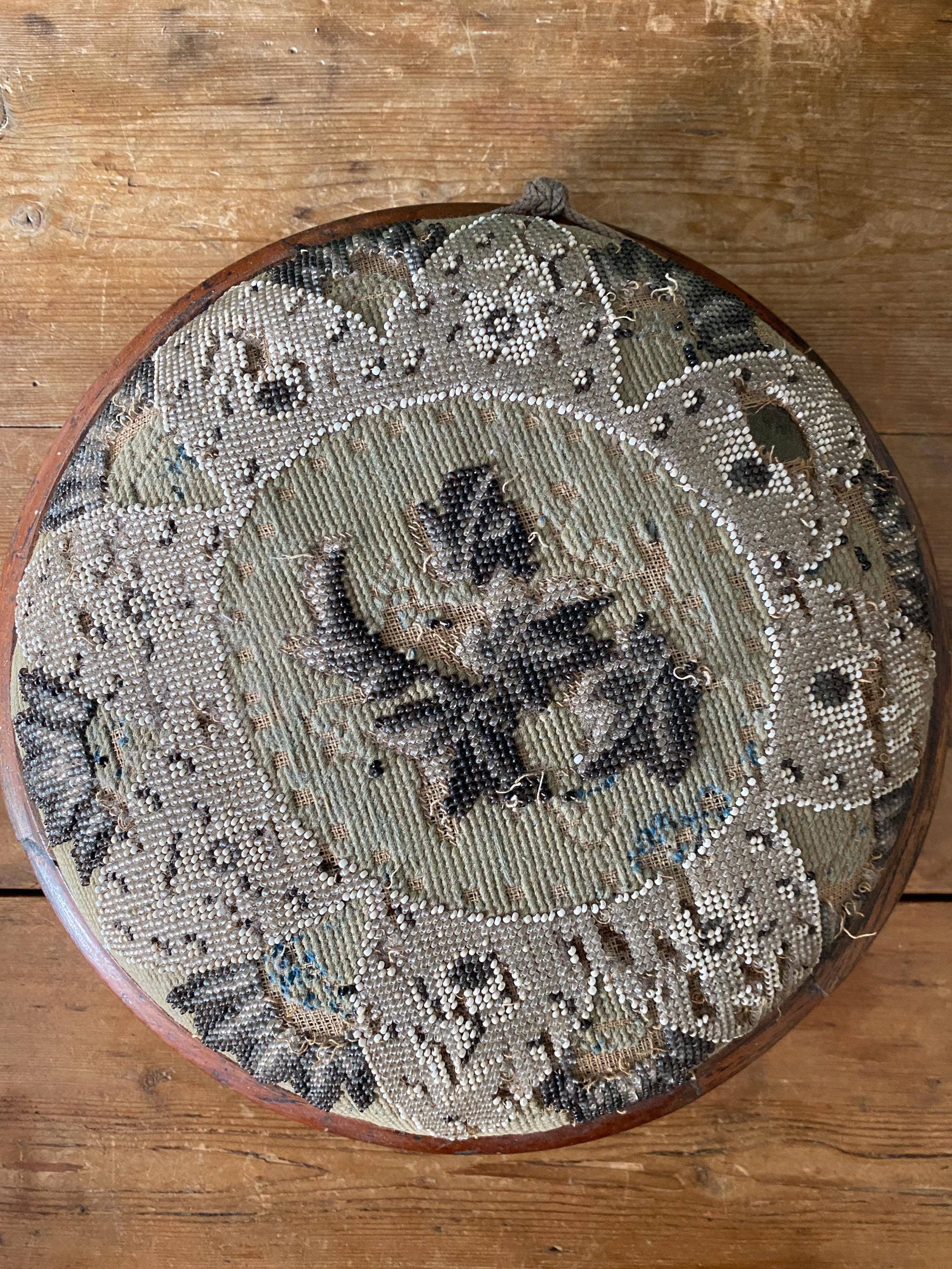 Decorative round footstool with embroidered design 