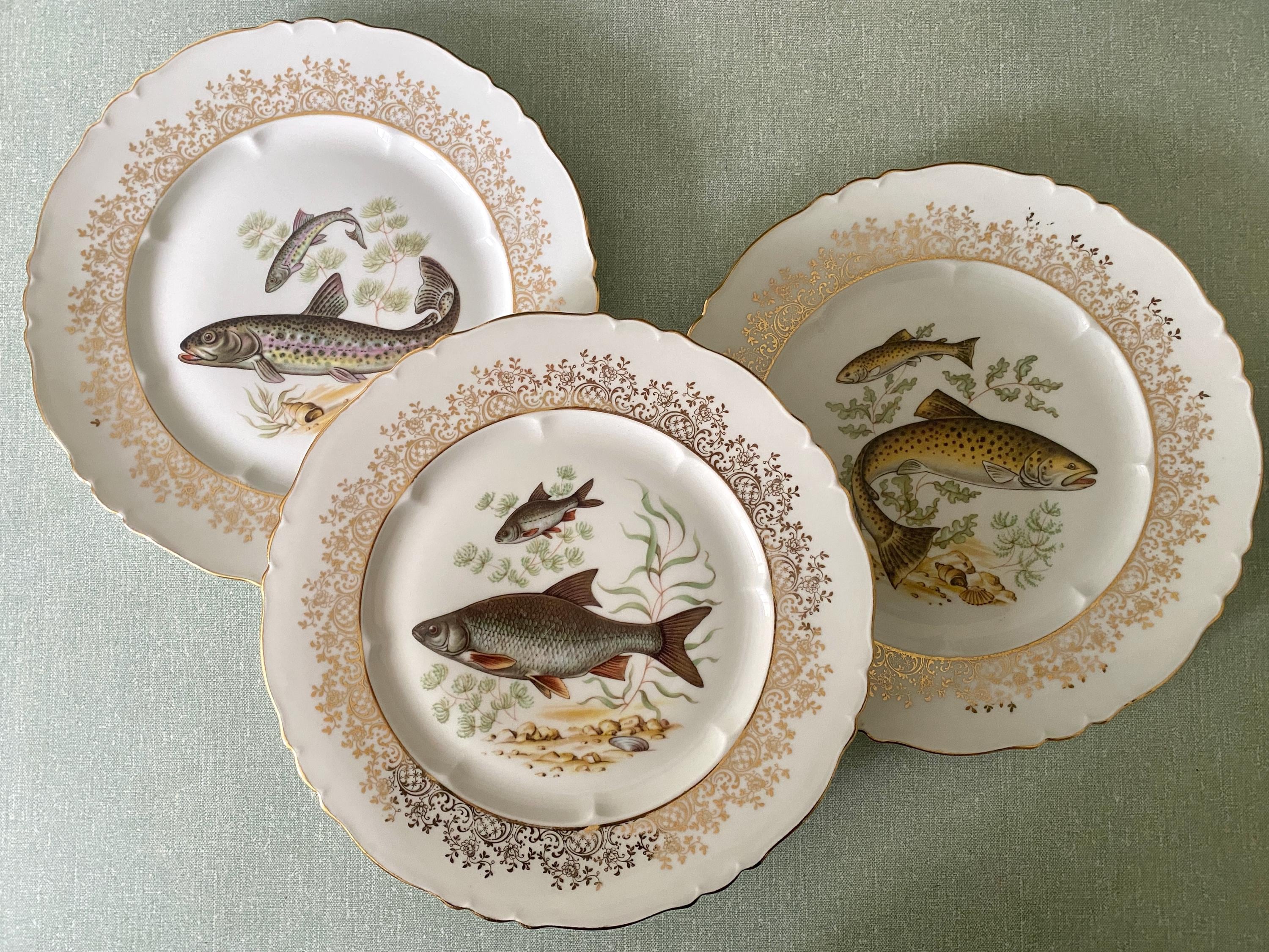 Set of three decorative plates with fish illustrations 
