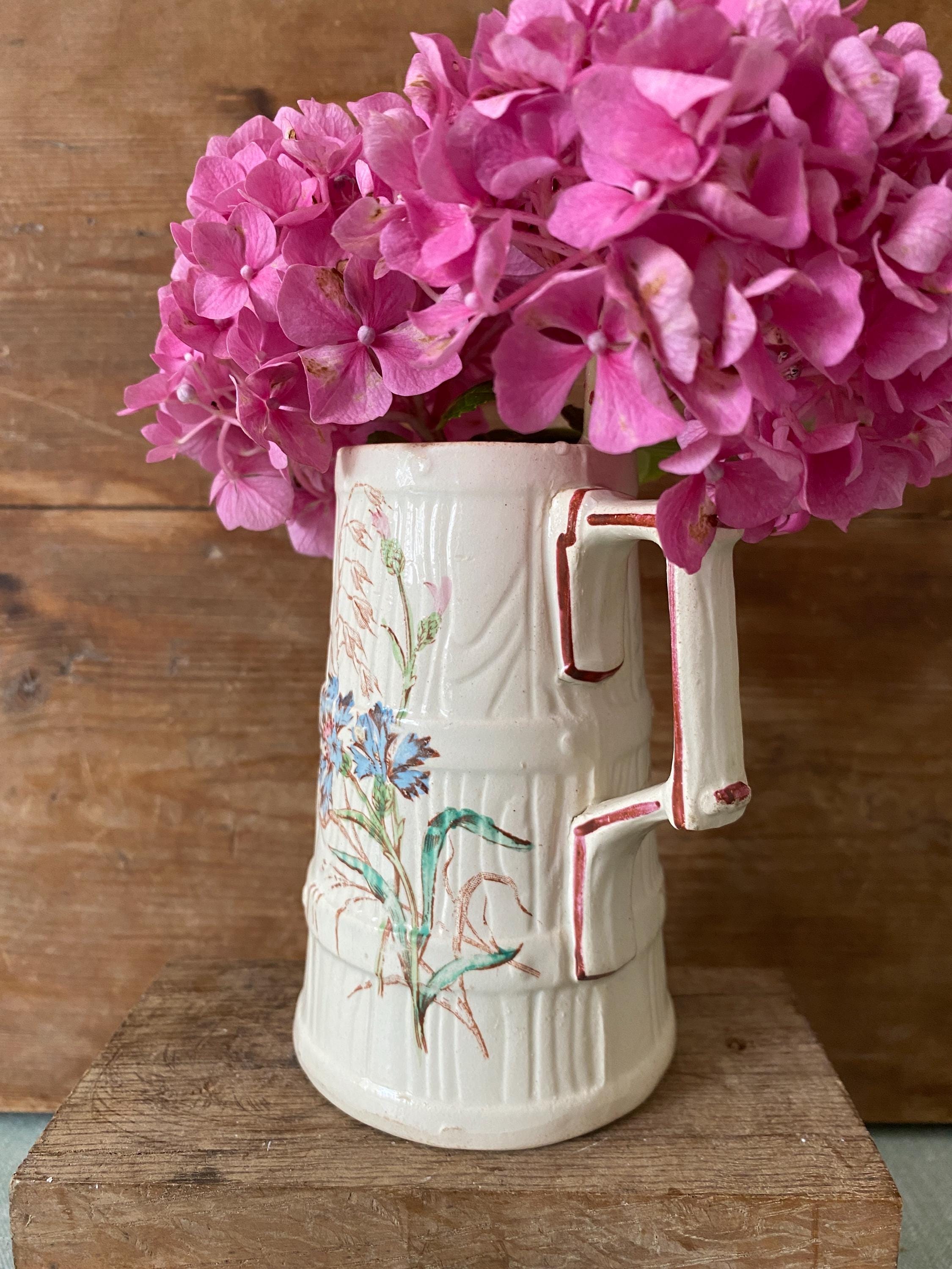 Antique jug with floral decoation
