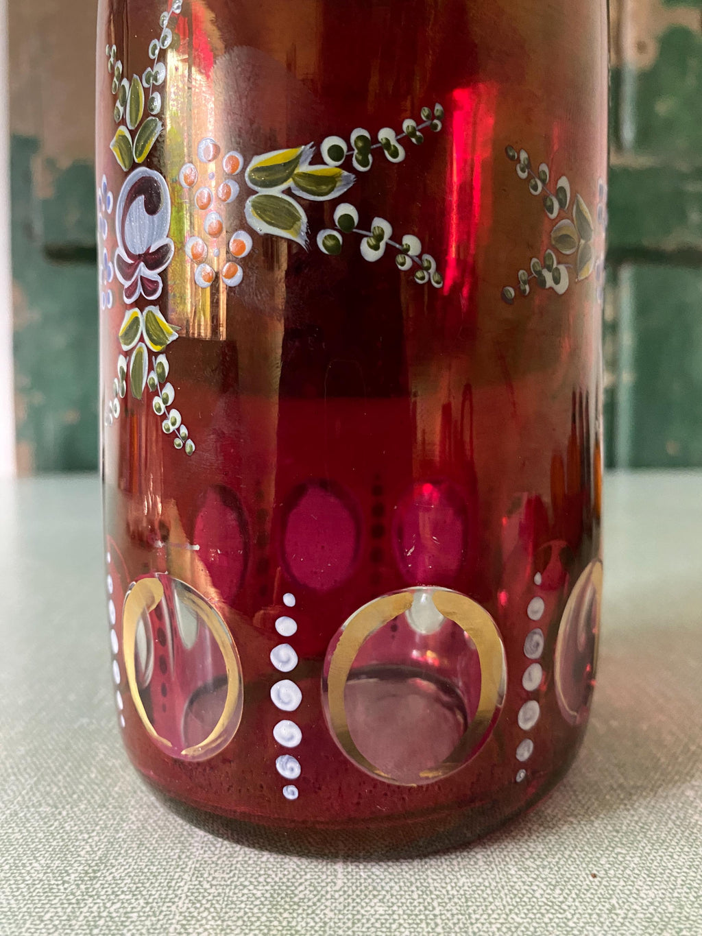 Decorative red glass bottle with floral patterns 
