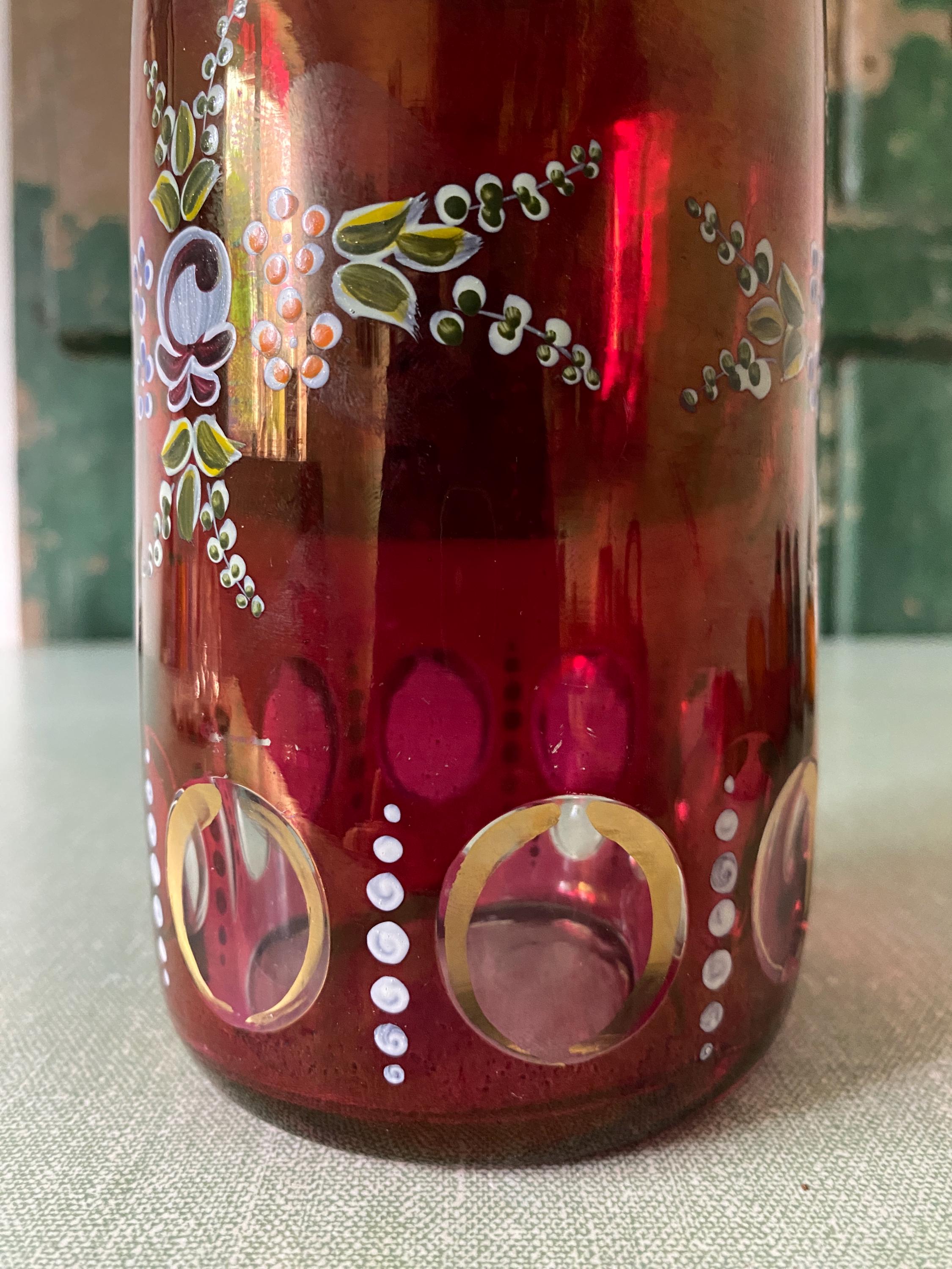 Decorative red glass bottle with floral patterns 