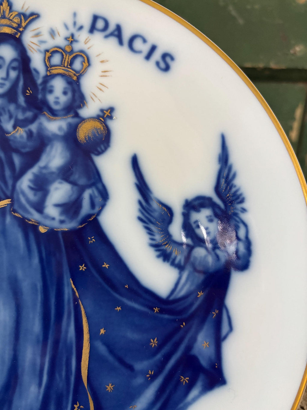 Blue and gold decorative plate with religious figures and 'PACIS' text on a white background