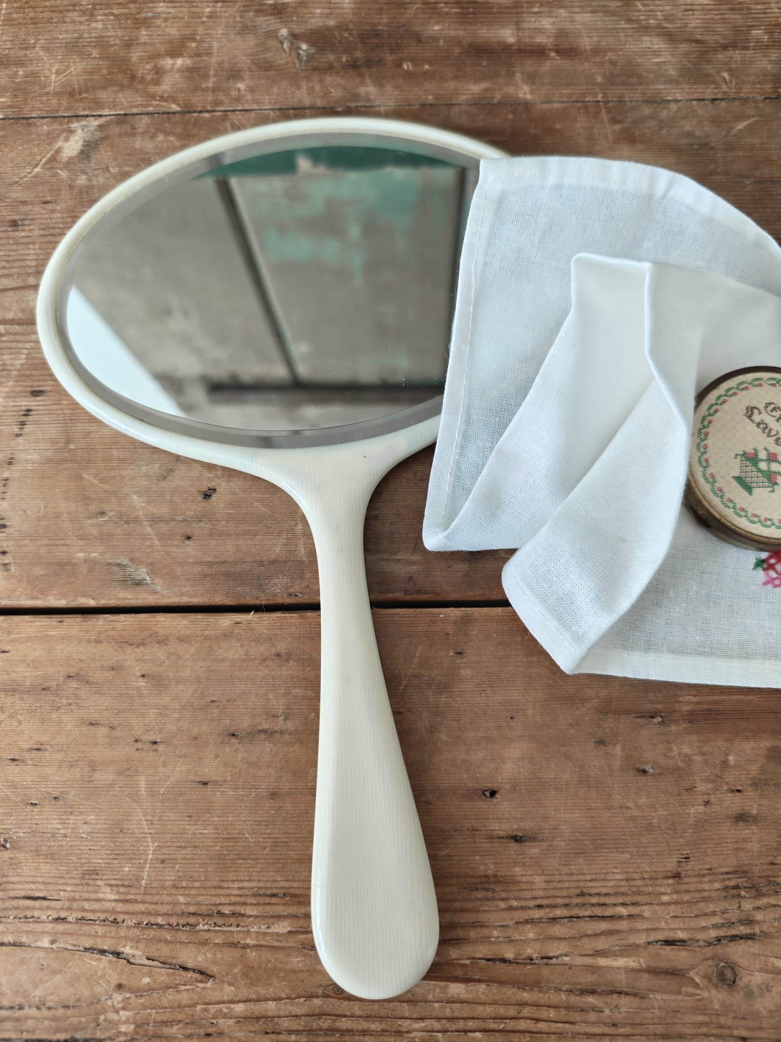 White hand held mirror