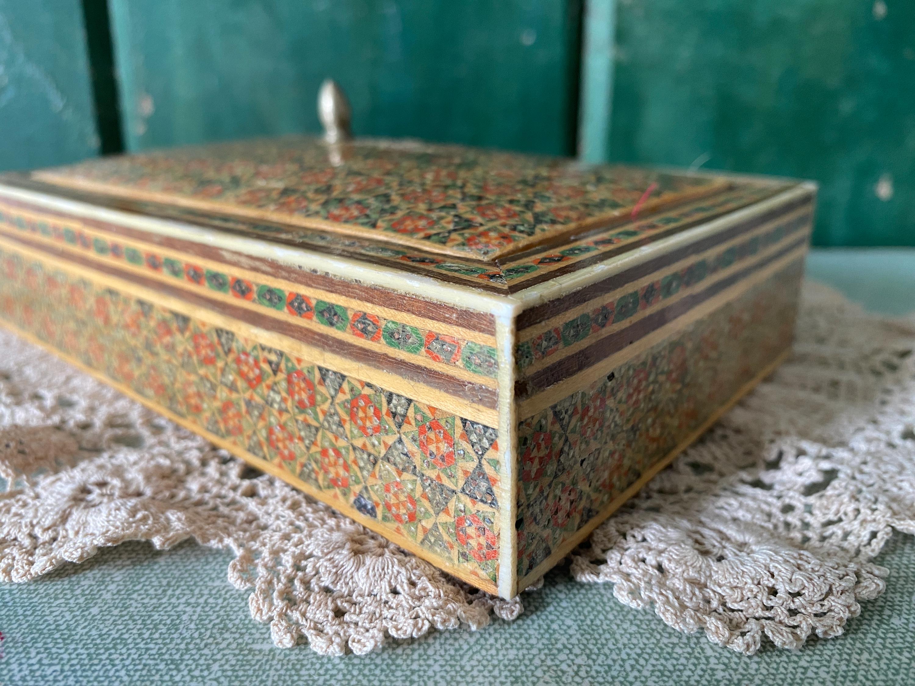 Decorative box with intricate red and green geometric patterns