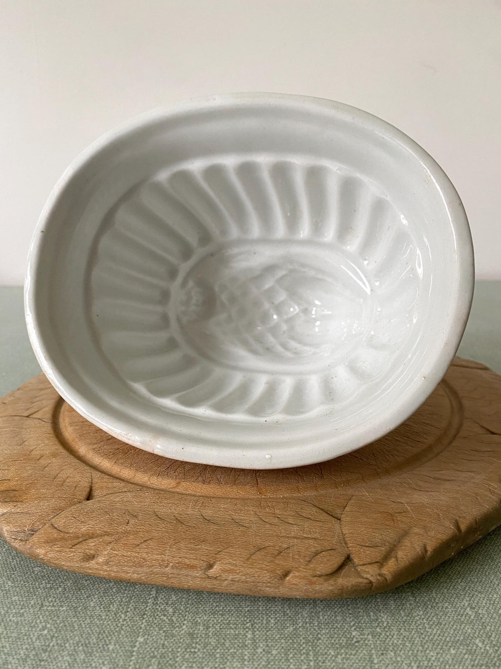 A white ceramic vintage jelly mould with thistle design