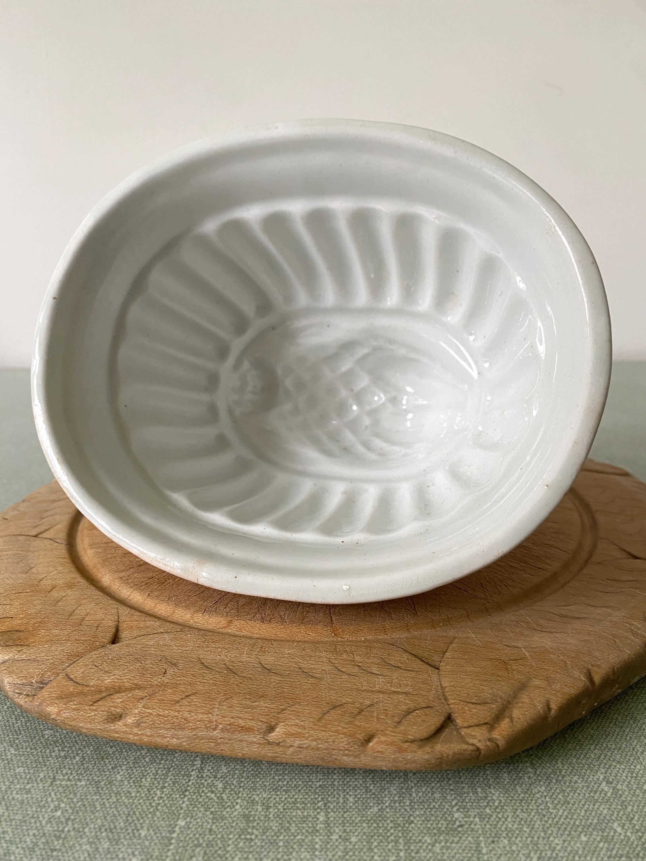 A white ceramic vintage jelly mould with thistle design