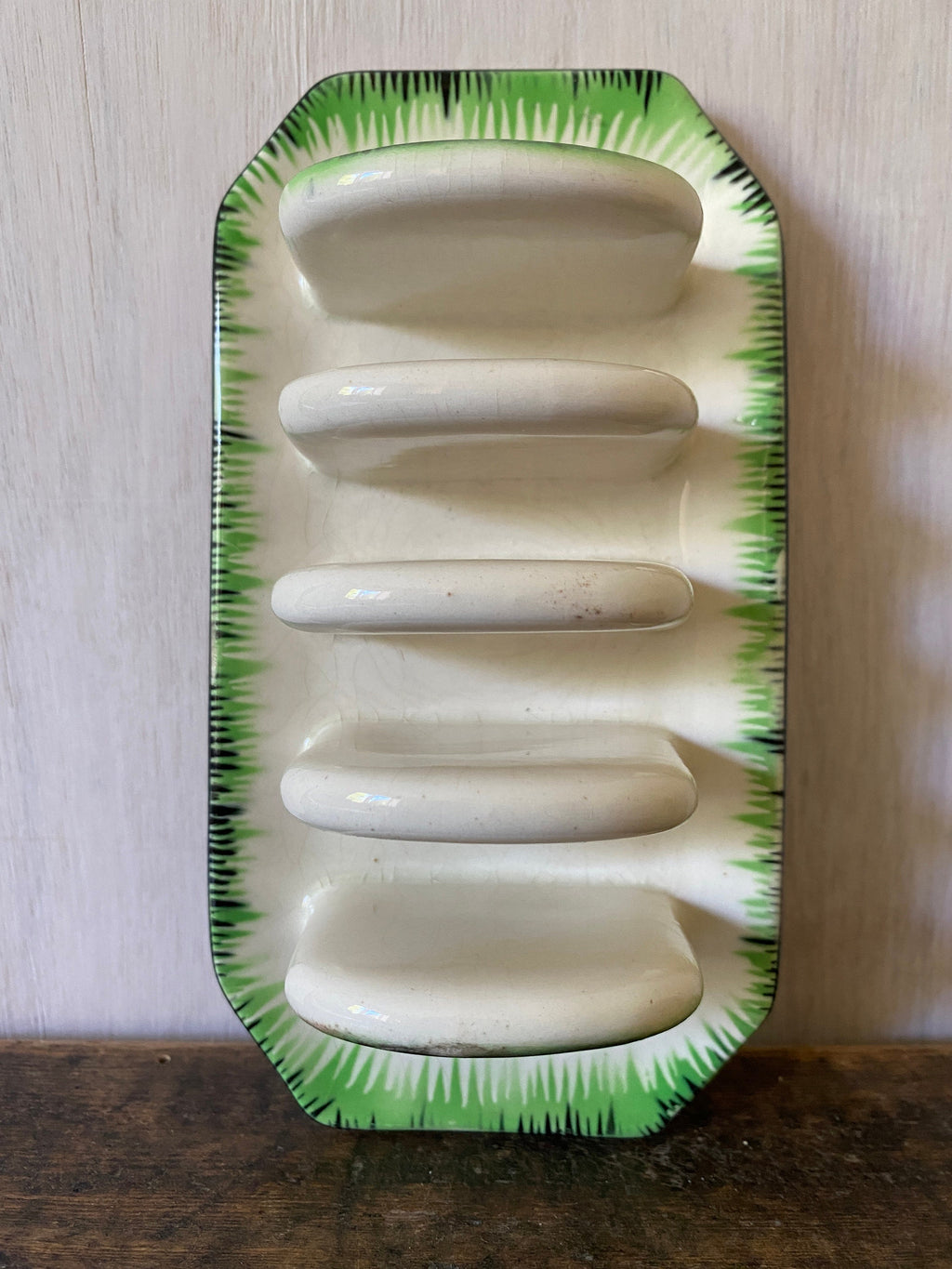 top view of a vintage ceramic toast rack with green decoration