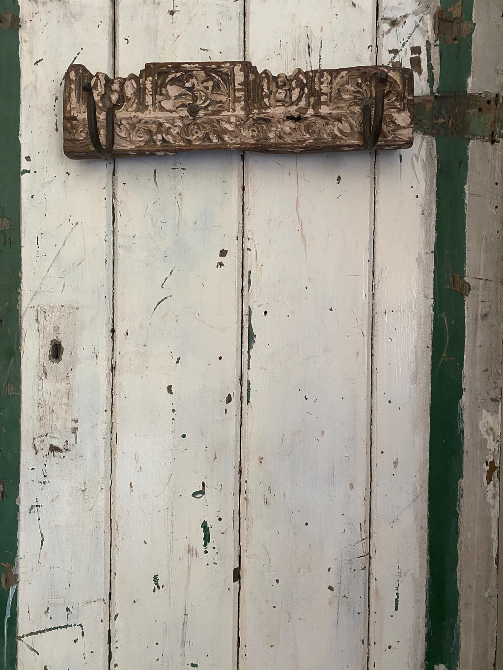 Rustic metal hook on a weathered wooden door